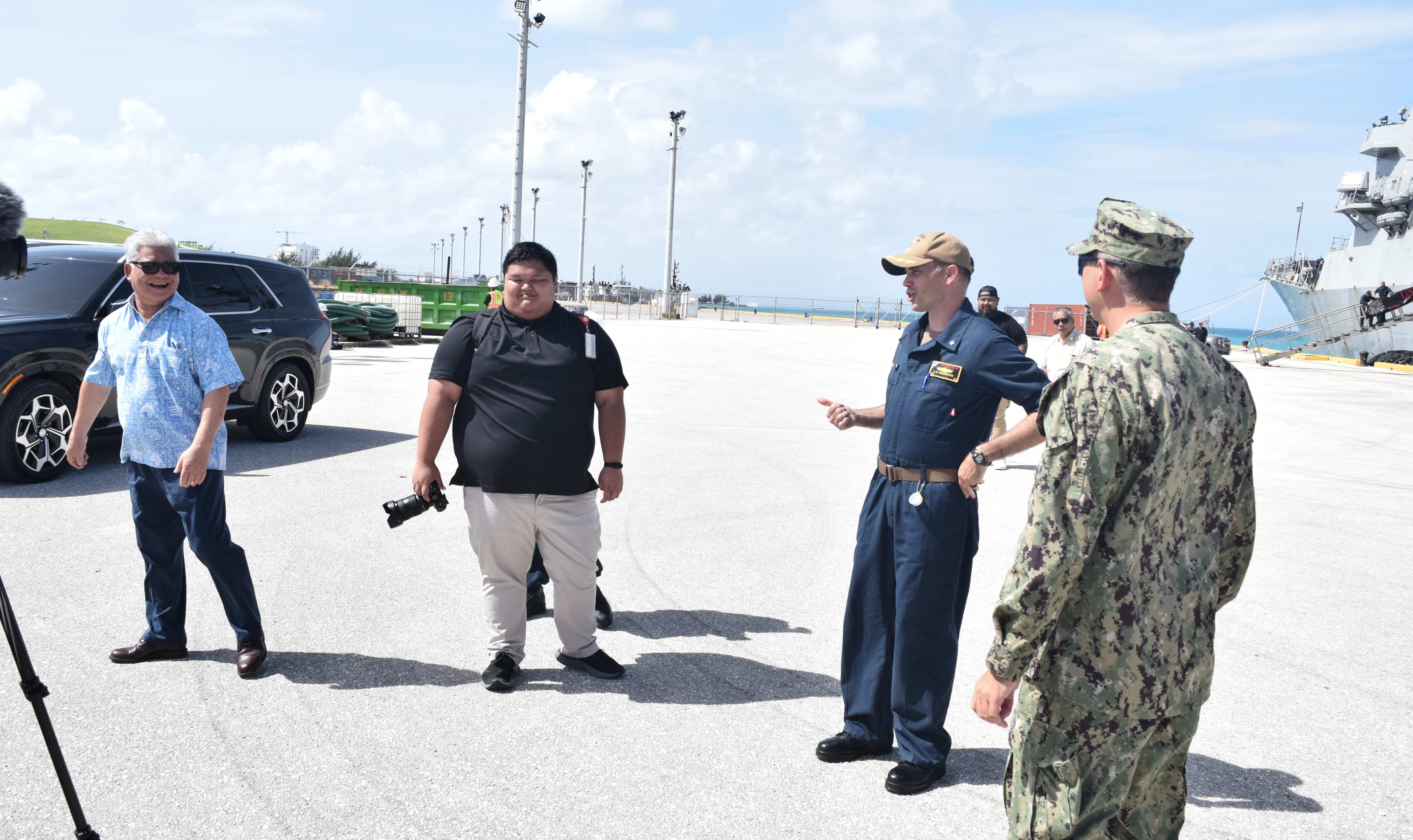 Gov. Arnold I. Palacios, left, smiles at USS Shoup commanding officer, Dale Tourtelotte, second right, at the Port of Saipan on Friday. Also in the photo is Office of the Governor media coordinator Ethan Kwon, center.