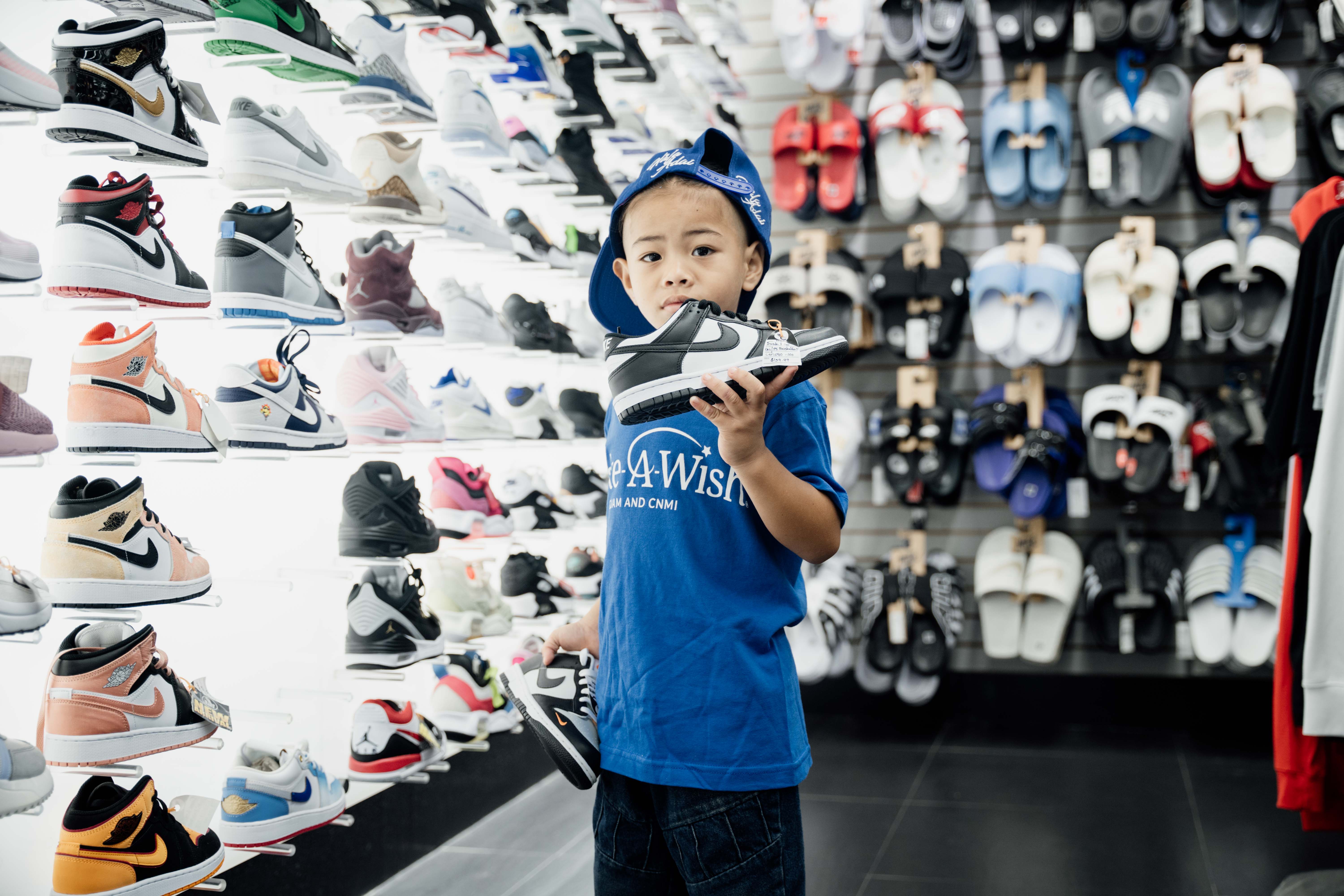 Andreas picks out one of several shoes on his shopping spree at The Athlete’s Foot.