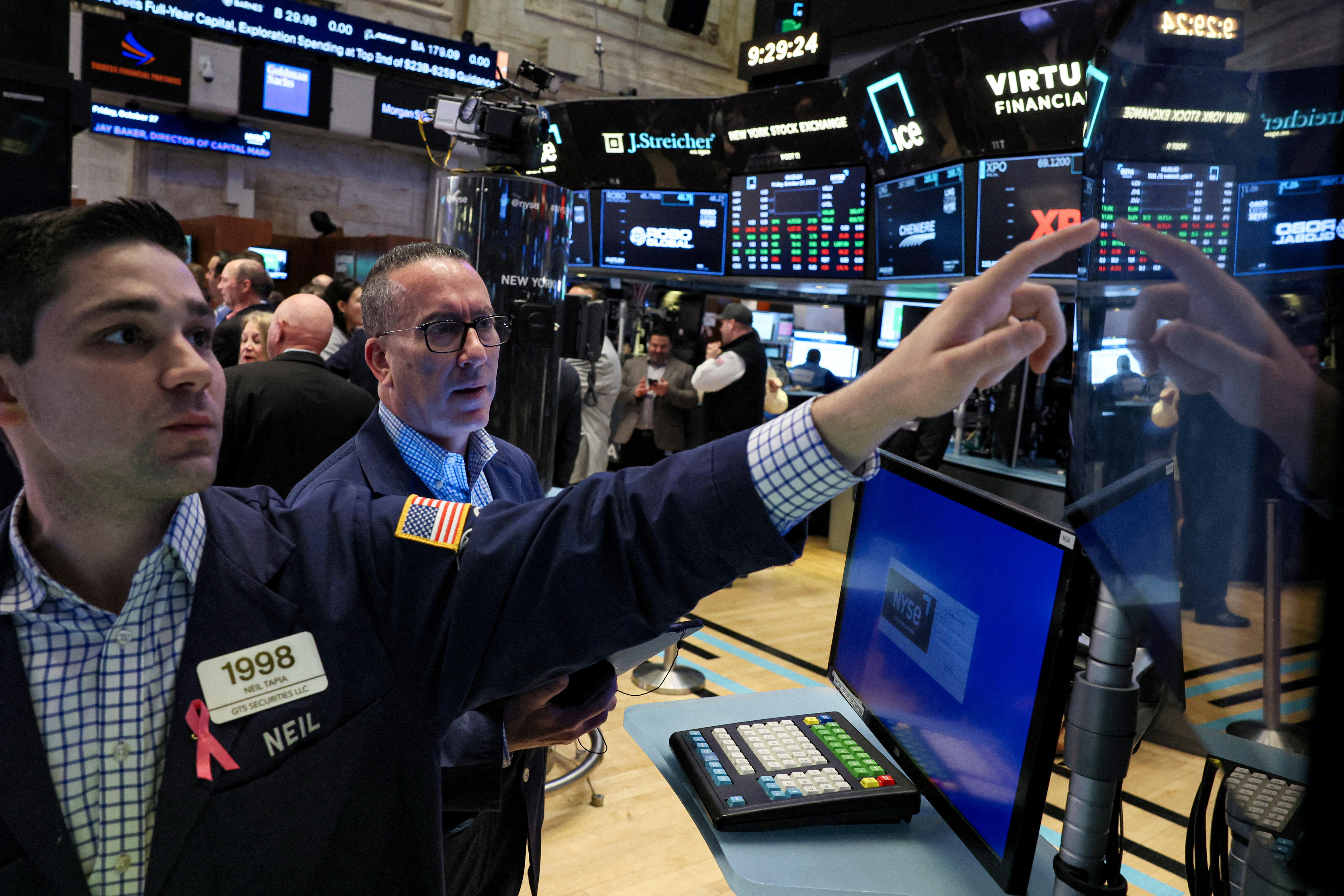 Traders work on the floor at the New York Stock Exchange (NYSE) in New York City, U.S., October 27, 2023. 