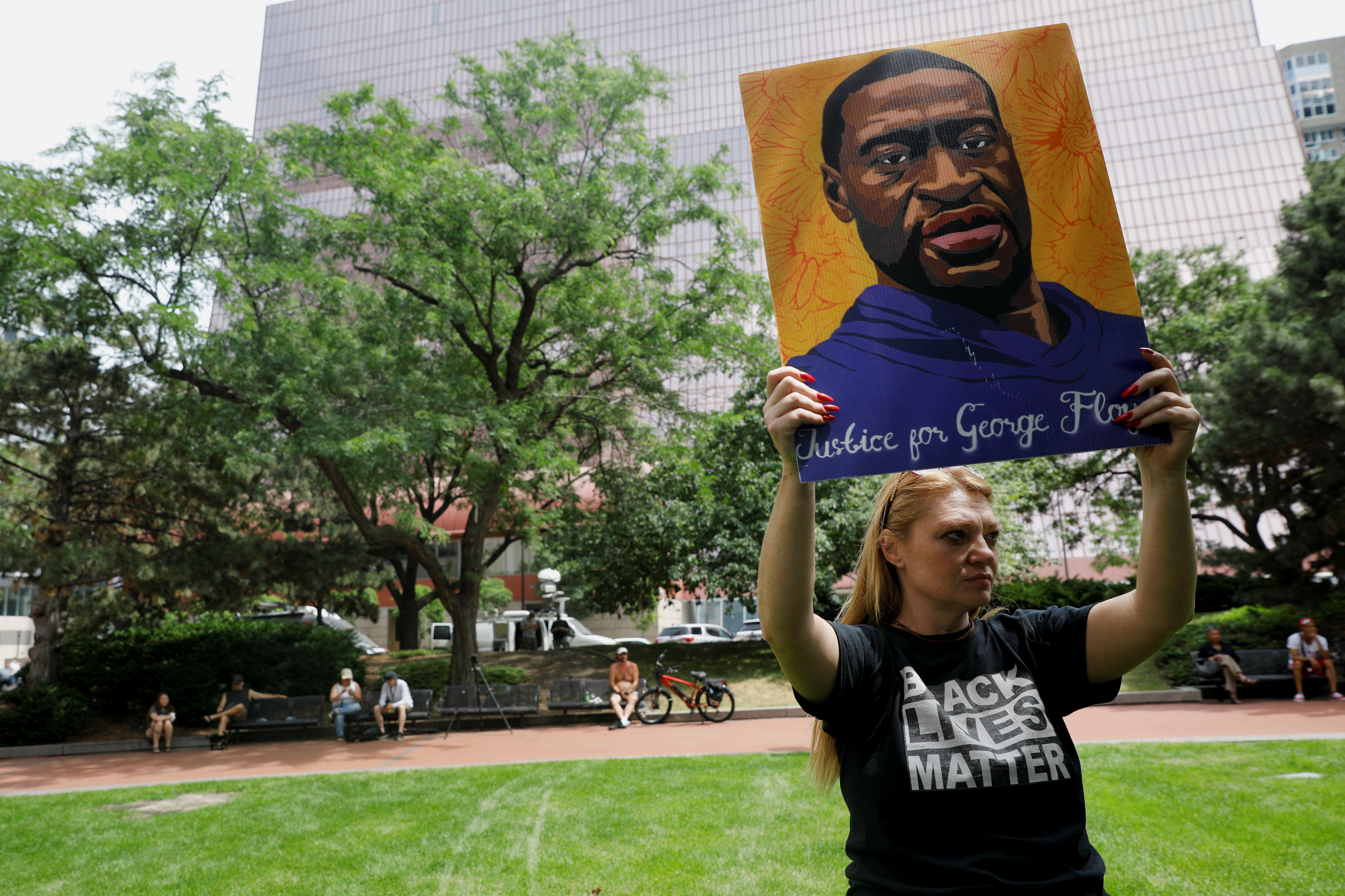 A person holds a portrait of George Floyd ahead of a sentence being pronounced on former police officer Derek Chauvin who was convicted for murdering George Floyd, in Minneapolis, Minnesota, U.S., June 25, 2021. 