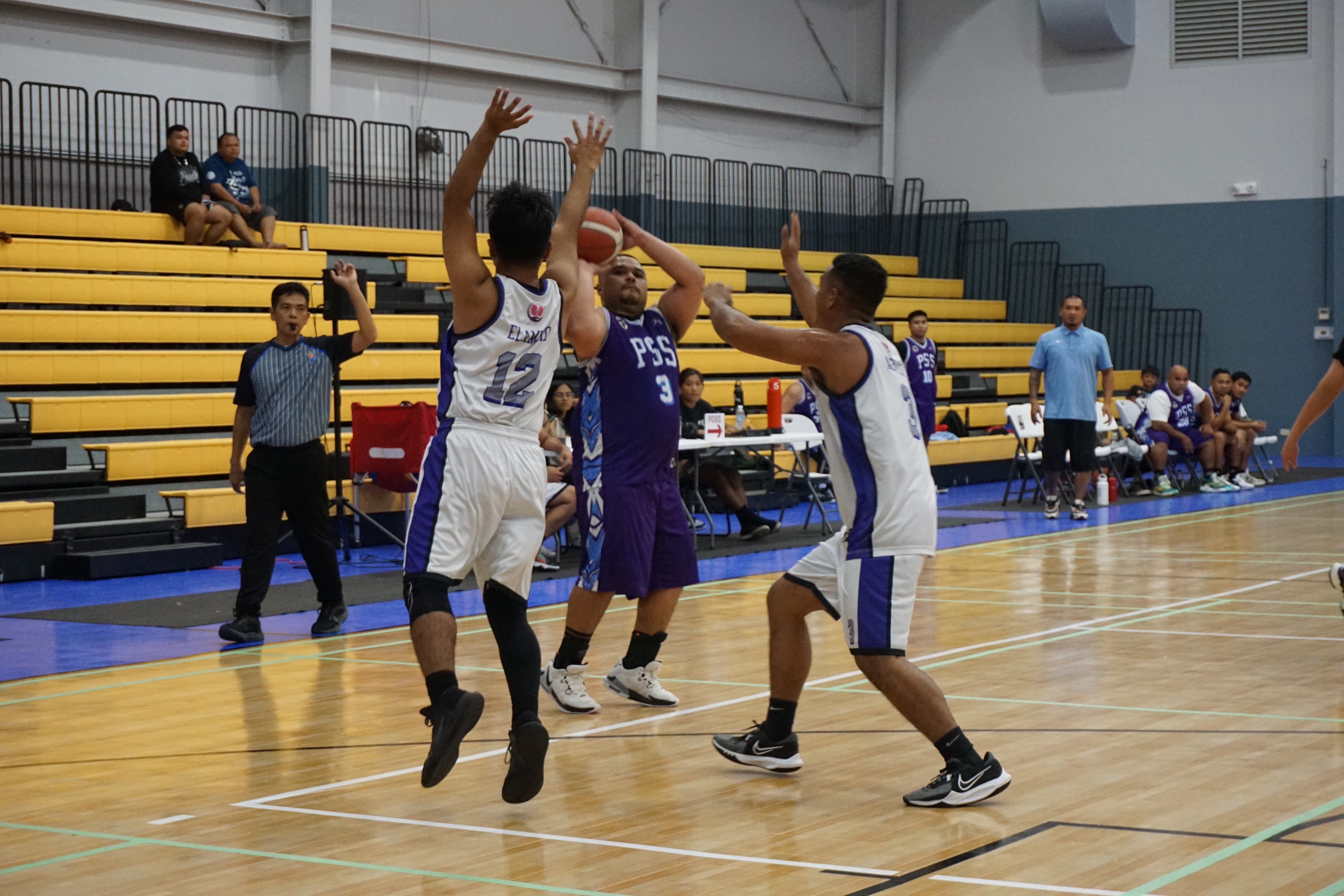 PSS's Preston Basa attempts a three-point shot over two defenders during a 2023 R&J Wine and Liquor Inter-Government/Business League game at the Ada gym.
