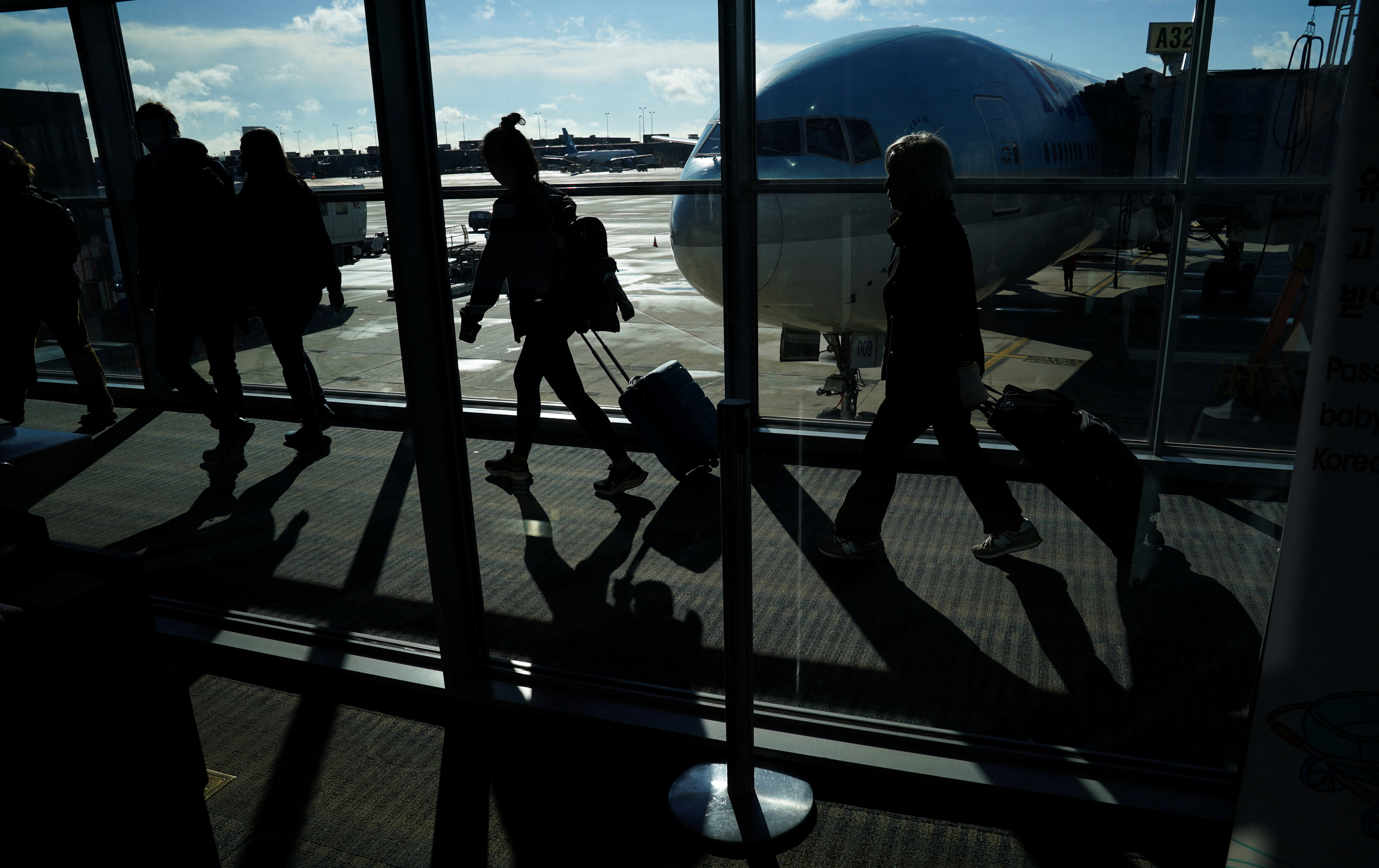 Passengers make their way through the terminal as they travel ahead of the Thanksgiving holiday at Washington Dulles International Airport in Dulles, Virginia, U.S., November 22, 2023. 