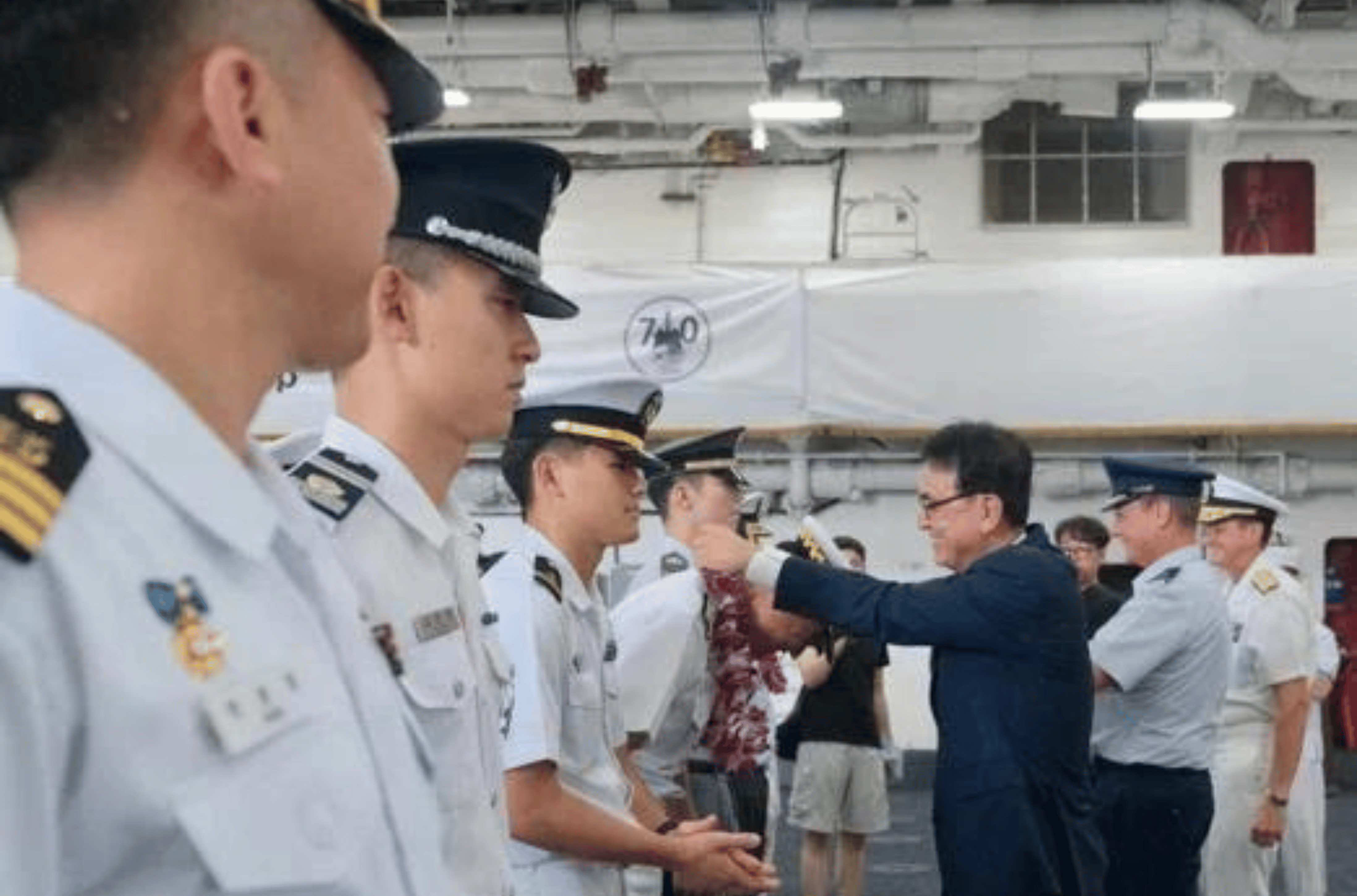 In Kook Kim, consul and head of consulate for the Consulate of the Republic of Korea in Hagåtña, gives a lei to a training cadet during an opening ceremony on the ROKS Dokdo at Victor Wharf on U.S. Naval Base Guam on Sunday, Nov. 12, 2023.  