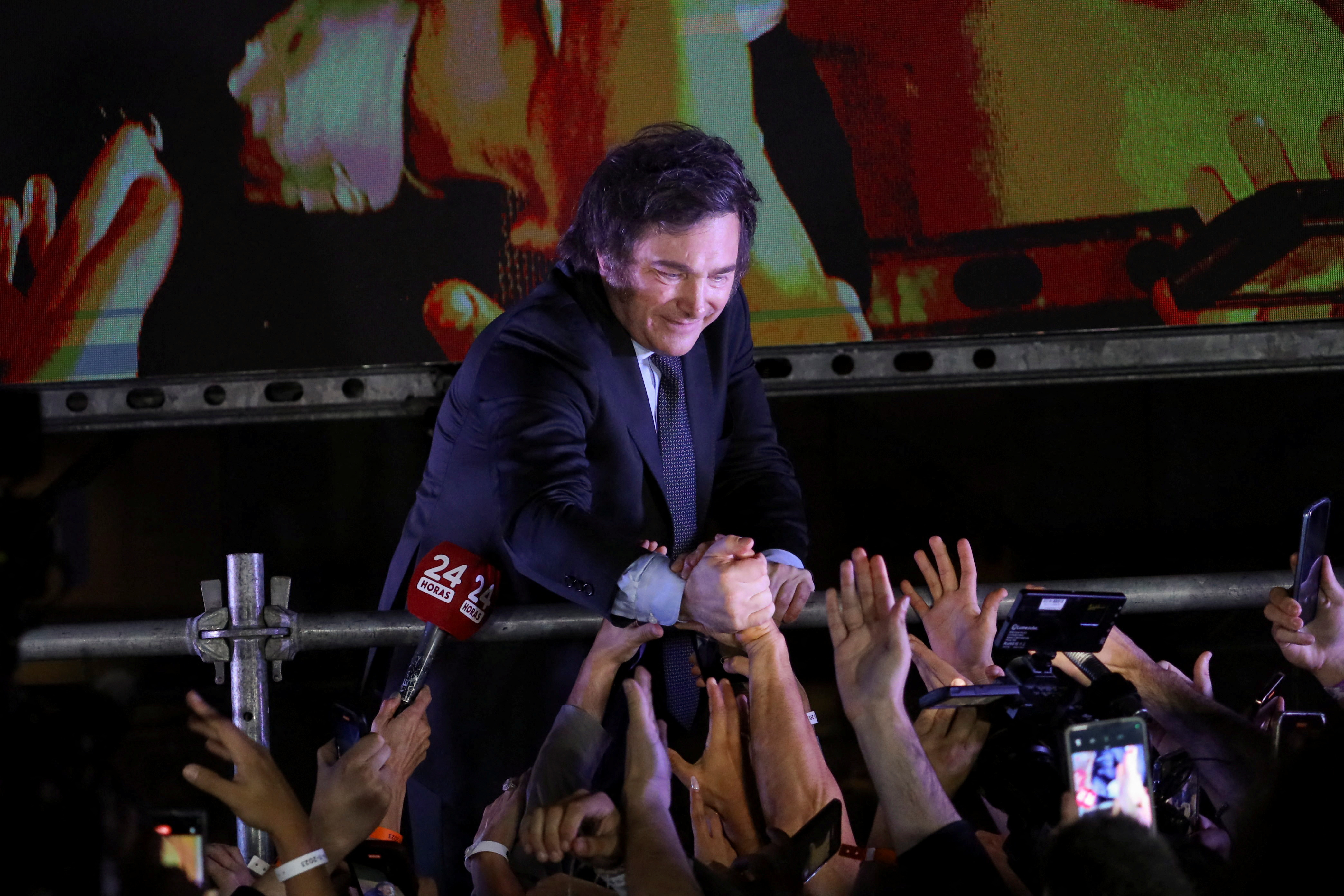 Argentine President-elect Javier Milei greets supporters after winning Argentina's runoff presidential election, in Buenos Aires, Nov. 19, 2023. 