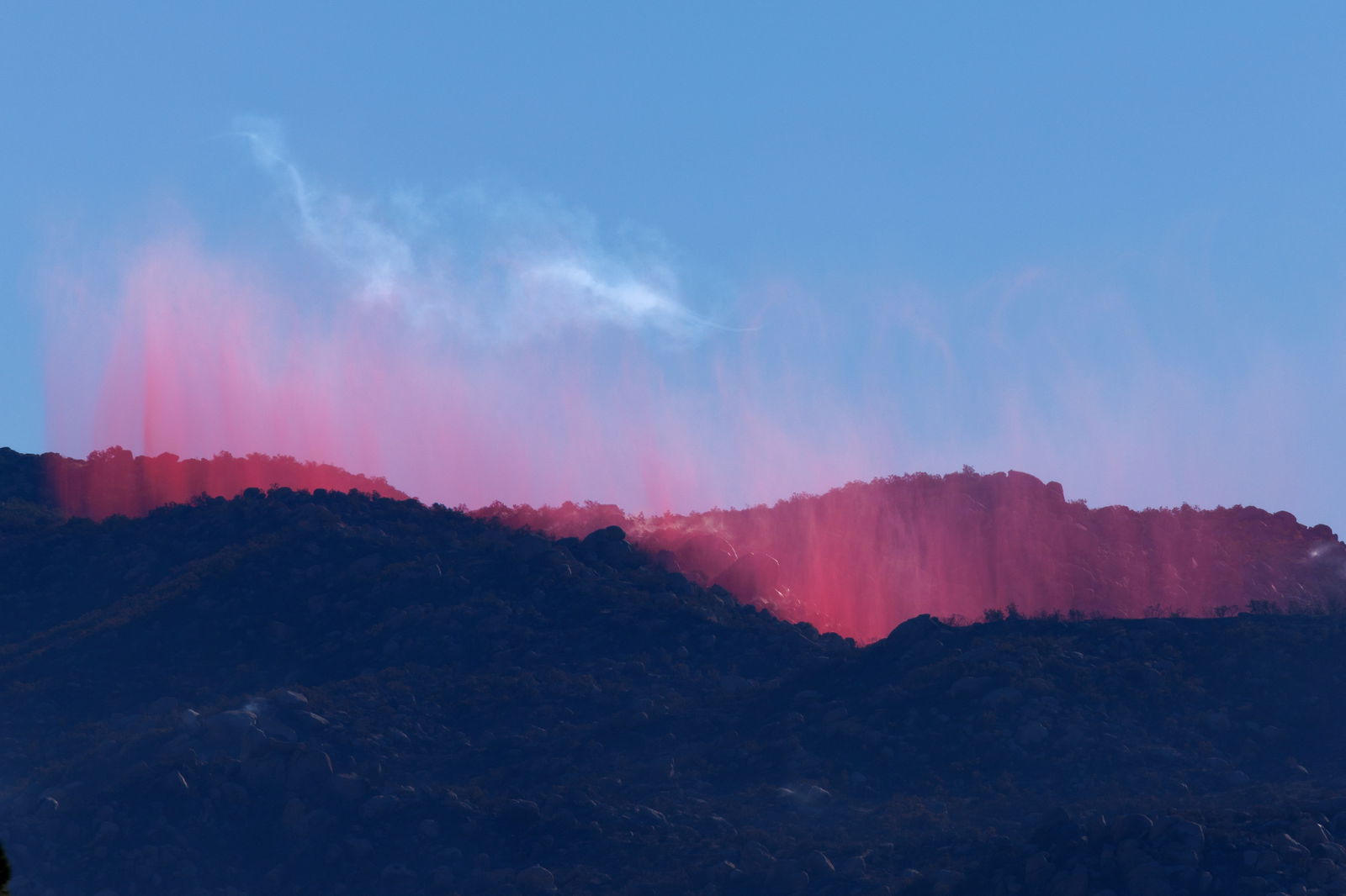Firefighters attack from the air as retardant falls on a hillside as they battle the Highland Fire, a wind- driven wildfire near Aguanga, California, U.S.,October 31, 2023. 