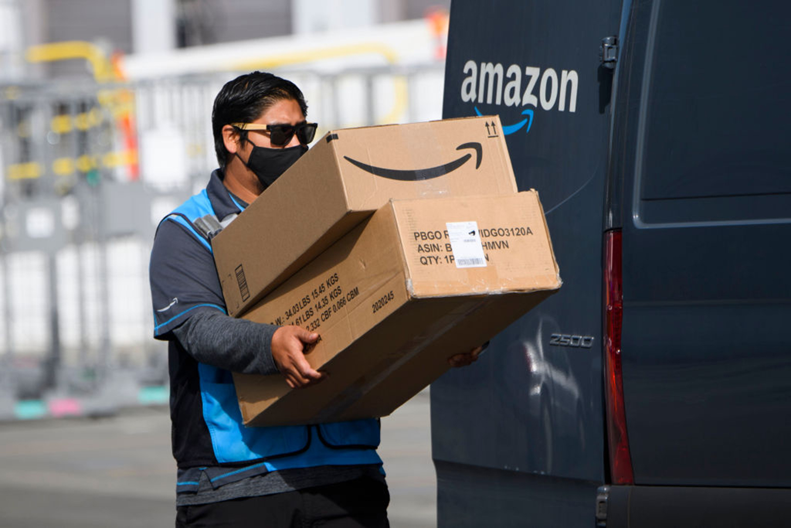 An Amazon delivery driver carries boxes into a van outside of a distribution facility on Feb. 2, 2021, in Hawthorne, California. (Patrick T. Fallon/AFP via Getty Images/TNS)