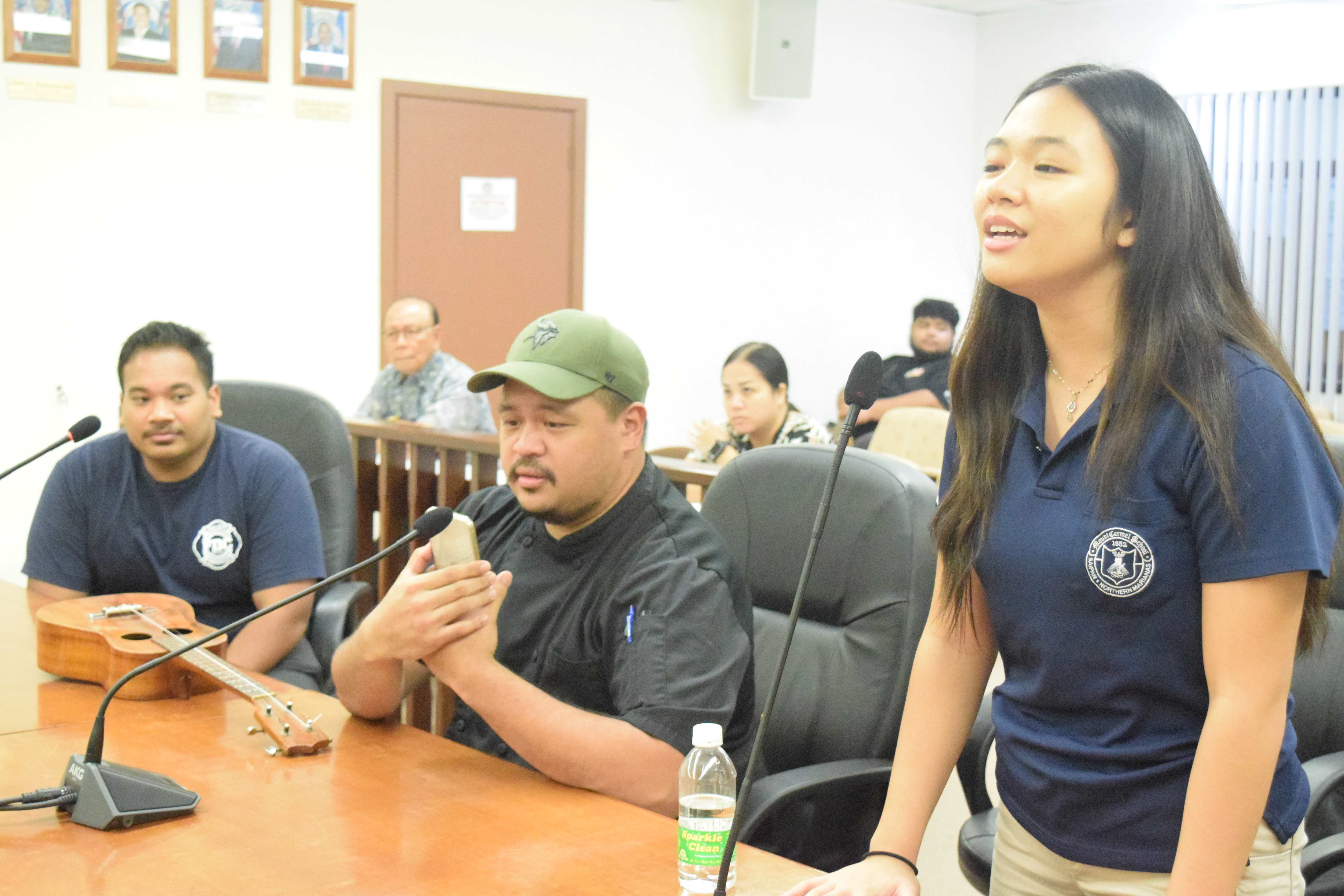 Marianas Got Talent finalist Bernice Sabino sings in the Senate chamber on Monday while two of the other finalists, Donovan Castro and Dwayne Castro, wait for their turn.