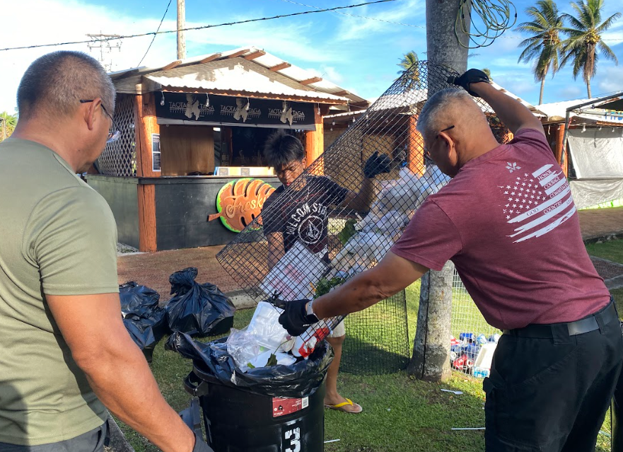 C/CSM Kelvin Shrestha assists the instructors, Capt. Joseph Santos and  1SG Jose King, with the trash pickup on the last day of the festival.
