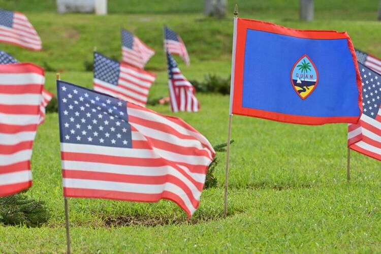U.S. and Guam flags, part of the Wreaths Across America event, are seen Sunday, Dec. 18, 2022, at the Guam Veterans Cemetery in Piti. 