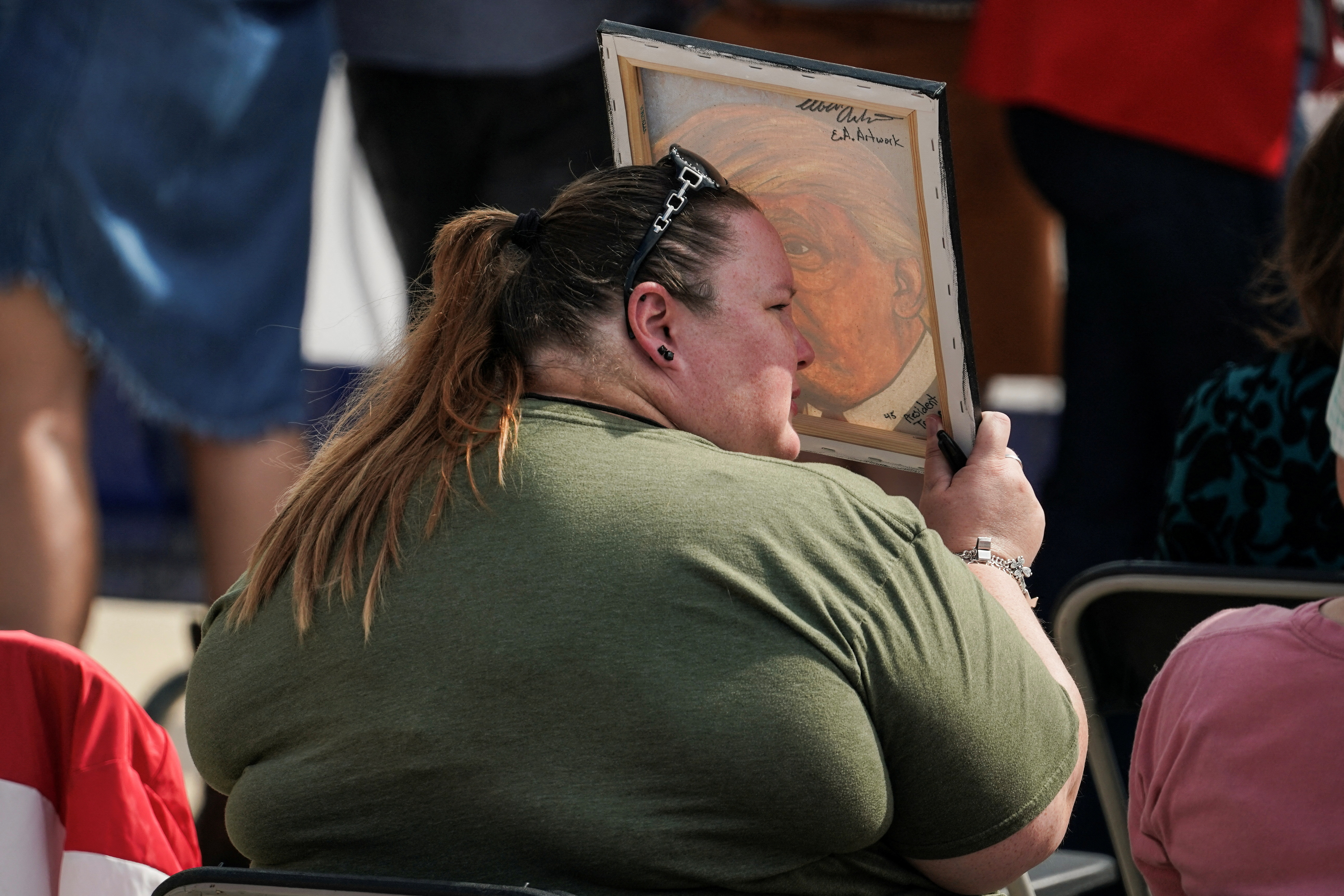 A Trump supporter waits for the event to start for former U.S. President Donald Trump during his visit at the southern border with Texas Governor Greg Abbott in Edinburg, Texas, U.S. November 19, 2023. 