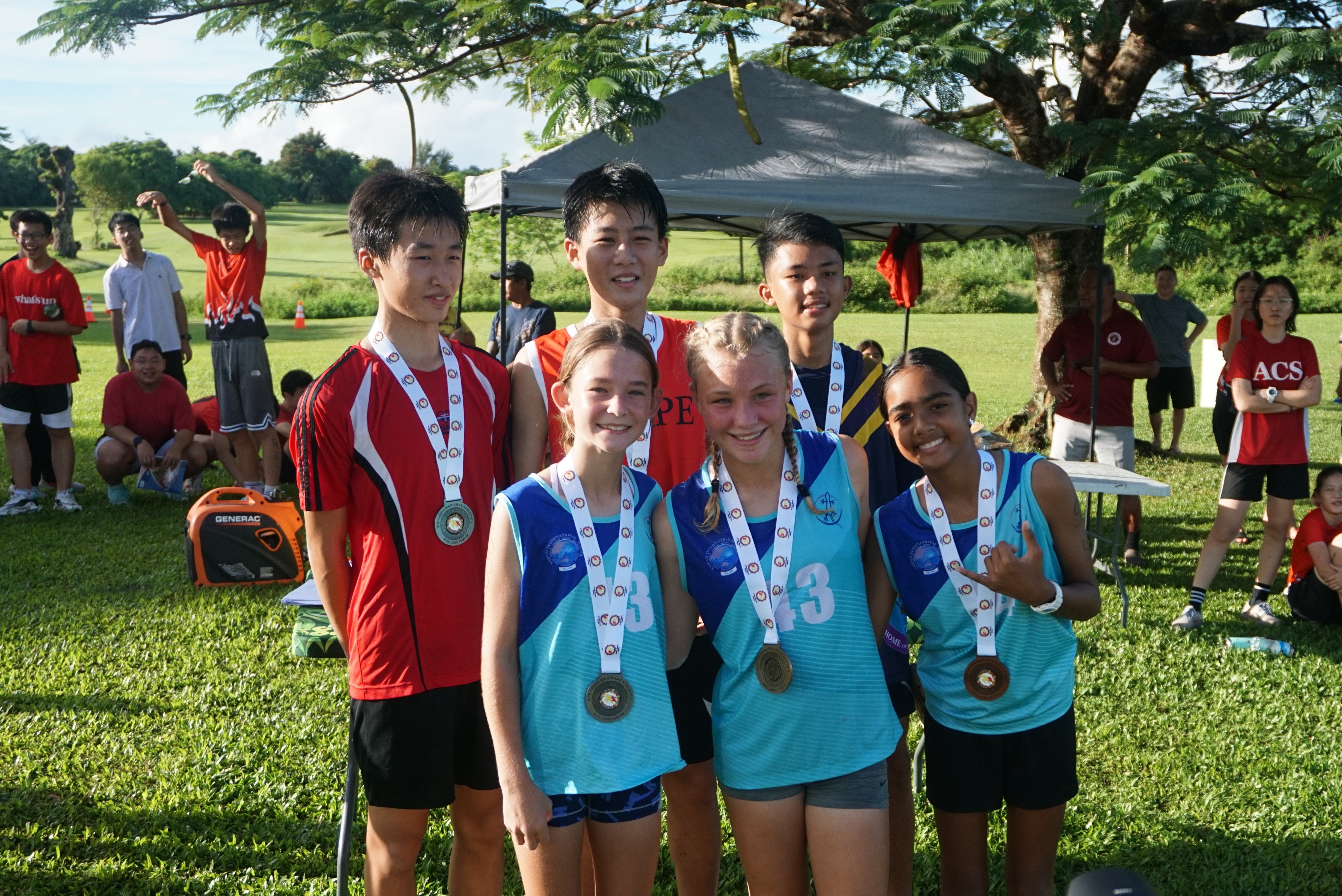 The top 3 runners of the middle school category pose for a photo during the awards ceremony of the PSS-NMA All School Cross Country Series SY23-24 on Saturday at the Saipan Country Club of Saipan Vegas.