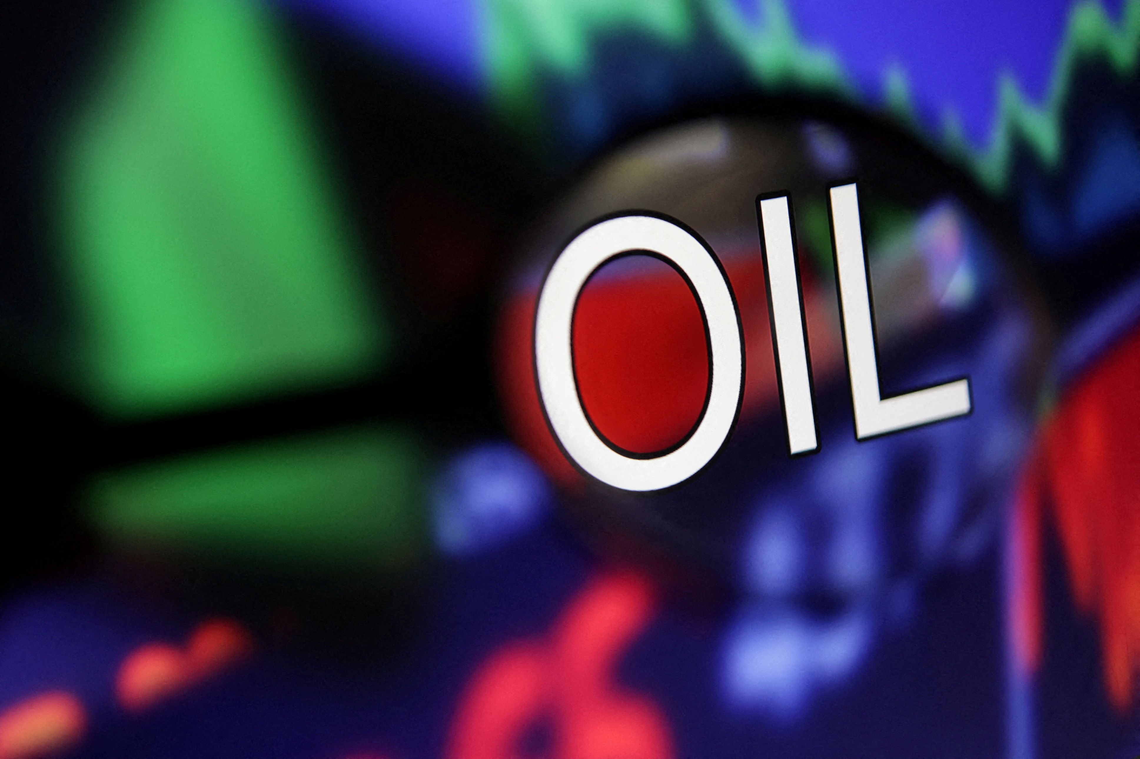 Word "Oil" and stock graph are seen through magnifier displayed in this illustration taken September 4, 2022. 