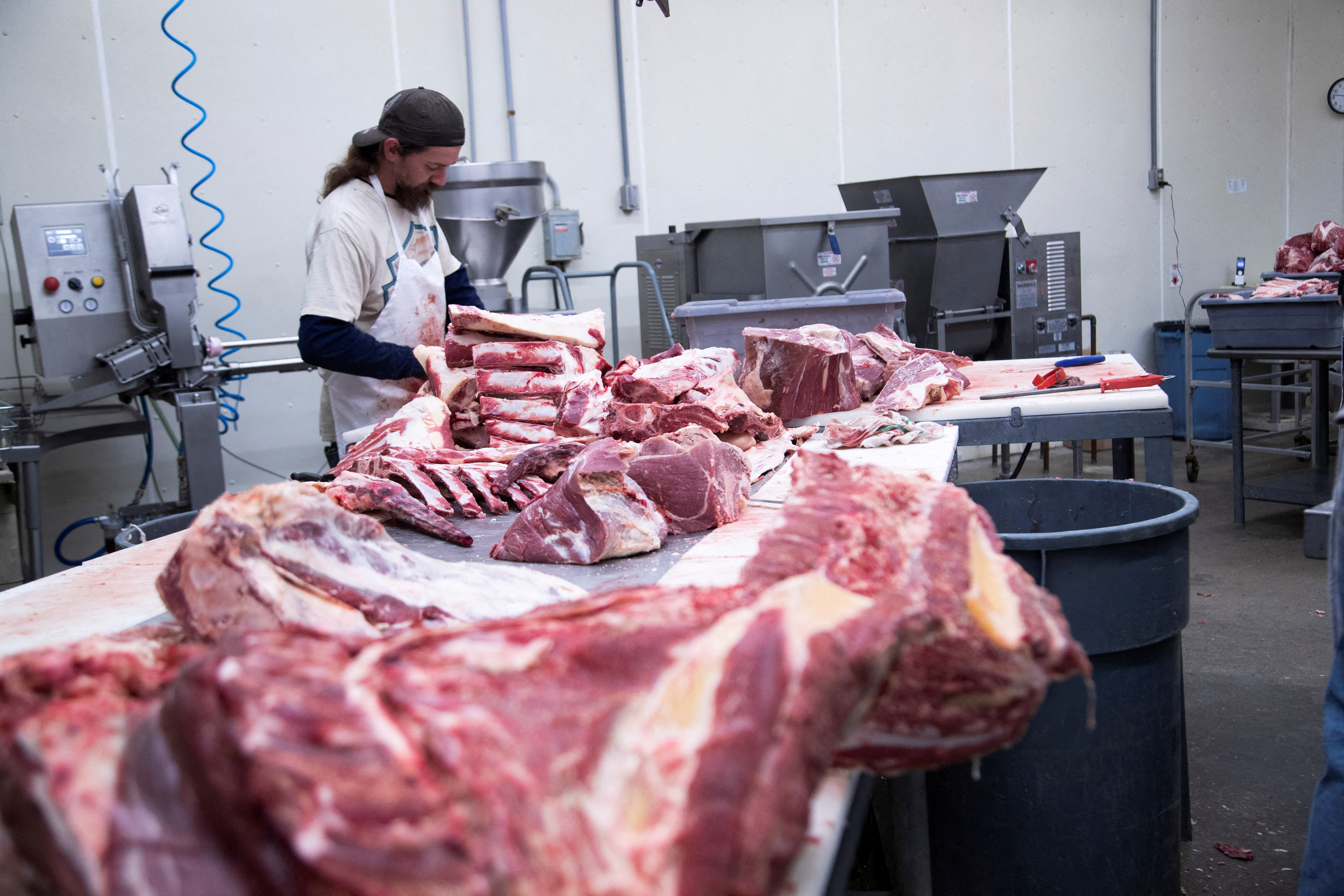 Employee cuts fresh beef meat into large pieces at the First Capitol Meat Processing plant in Corydon, Indiana U.S. January 31, 2022. 