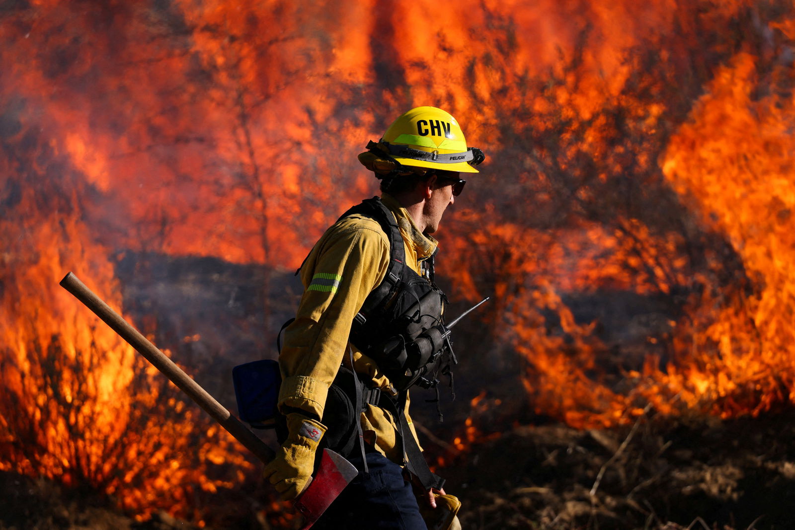 A firefighter works to extinguish the Highland Fire, a wind driven wildfire near Aguanga, California, U.S., October 31, 2023. 