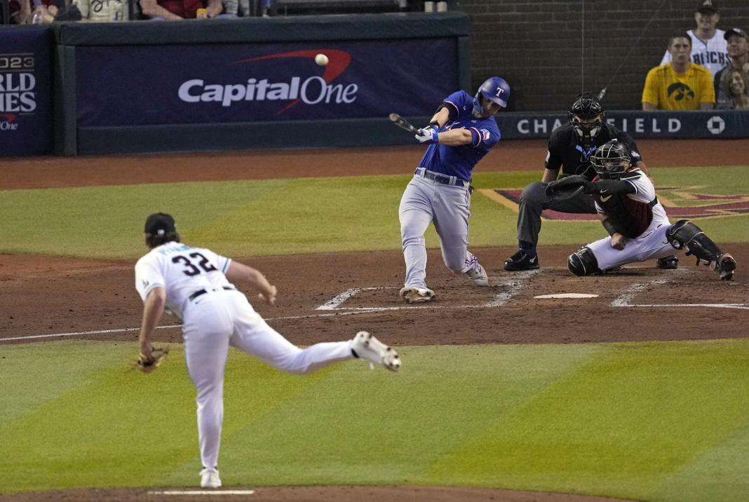 Texas Rangers Corey Seager hits a two-run home run off Arizona Diamondbacks starting pitcher Brandon Pfaadt during the third inning in Game 3 of the World Series Monday, Oct. 30, 2023 in Phoenix.