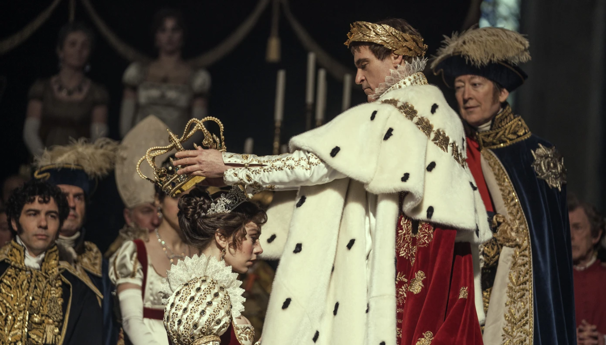 Vanessa Kirby, foreground left, and Joaquin Phoenix in a scene from “Napoleon.”