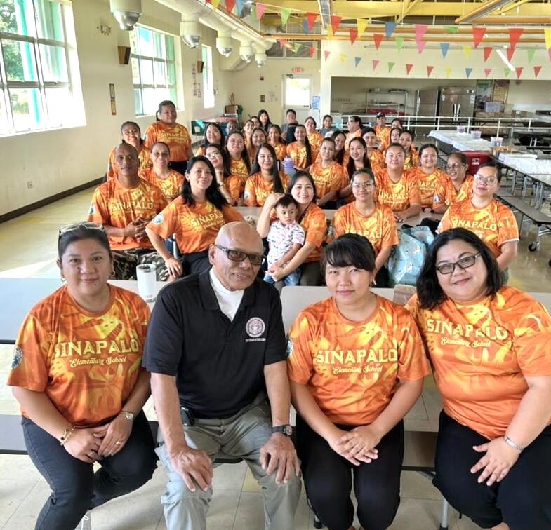 Sinapalo Elementary School personnel and staff, led by Principal Daisy Quitugua, pose for a photo with Board of Education Vice Chair Herman Atalig during their Education Day celebration.