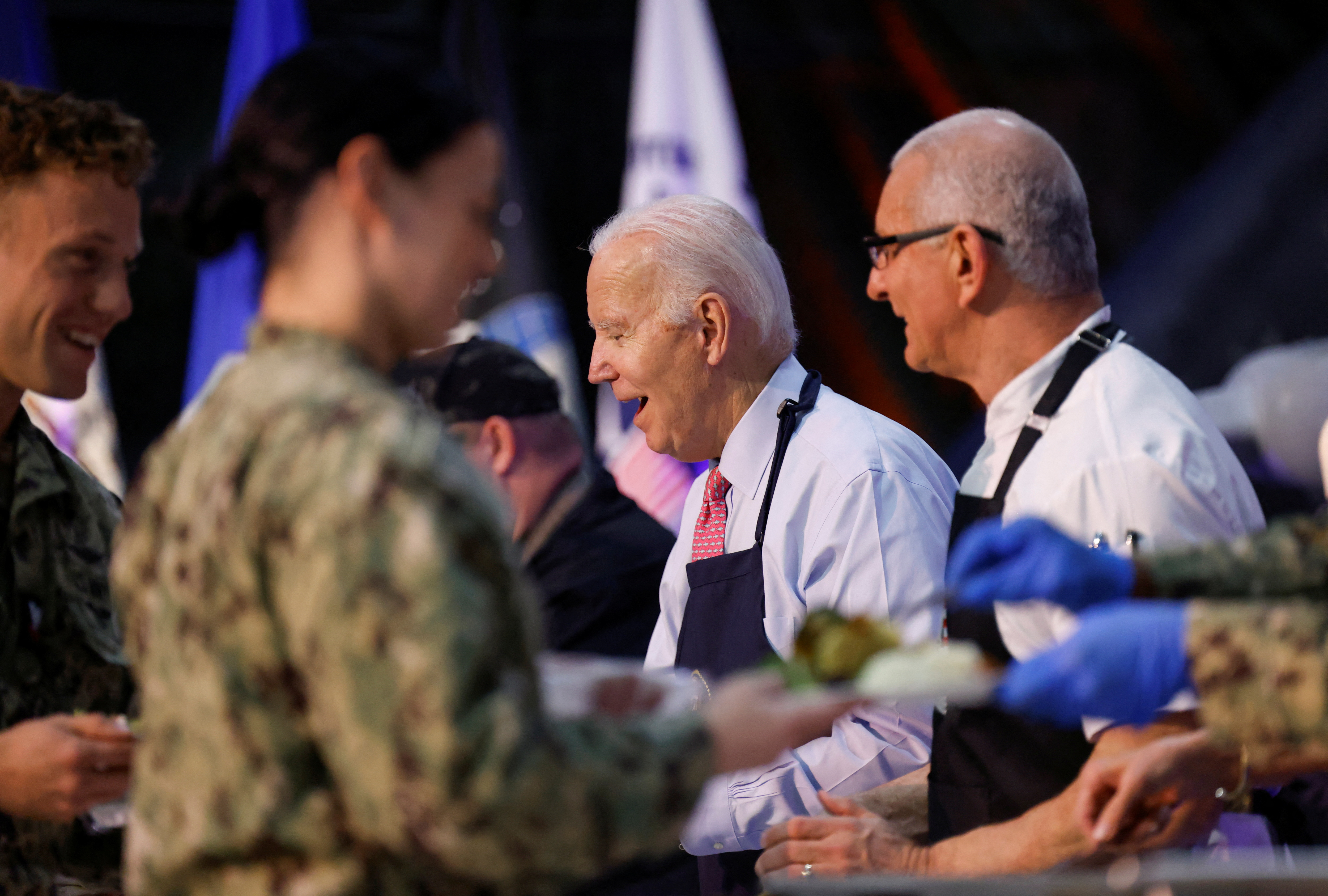 U.S. President Joe Biden serves food to service members and their families ahead of the Thanksgiving holiday during a "Friendsgiving" at Naval Station Norfolk in Norfolk, Virginia, U.S., November 19, 2023. 
