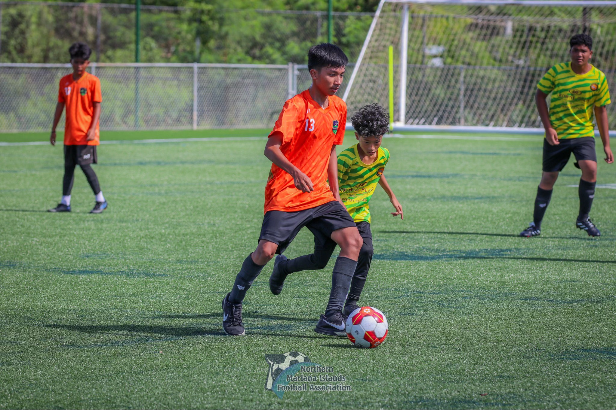 Kanoa's Dartagni Enerio dribbles past a defender during a U14 boys division game of the TakeCare Youth Soccer League Fall 2023 at the NMI Soccer Training Center in Koblerville on Saturday. 