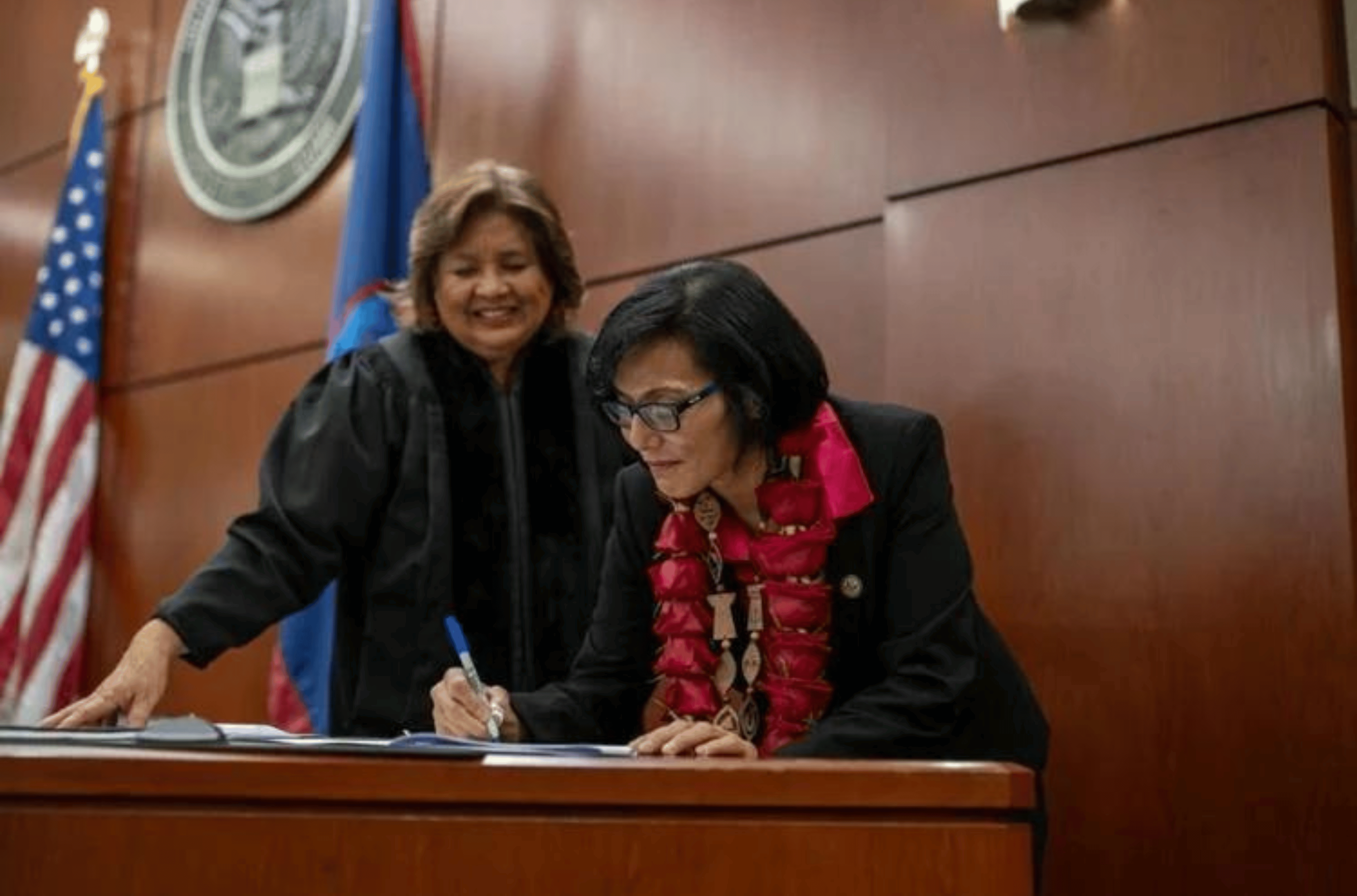 Leilani Lujan signs a document Wednesday, Nov. 15, 2023, at the U.S. District Court of Guam during her private swearing-in ceremony to be the federal public defender, as Chief Judge Frances Tydingco-Gatewood looks on.   