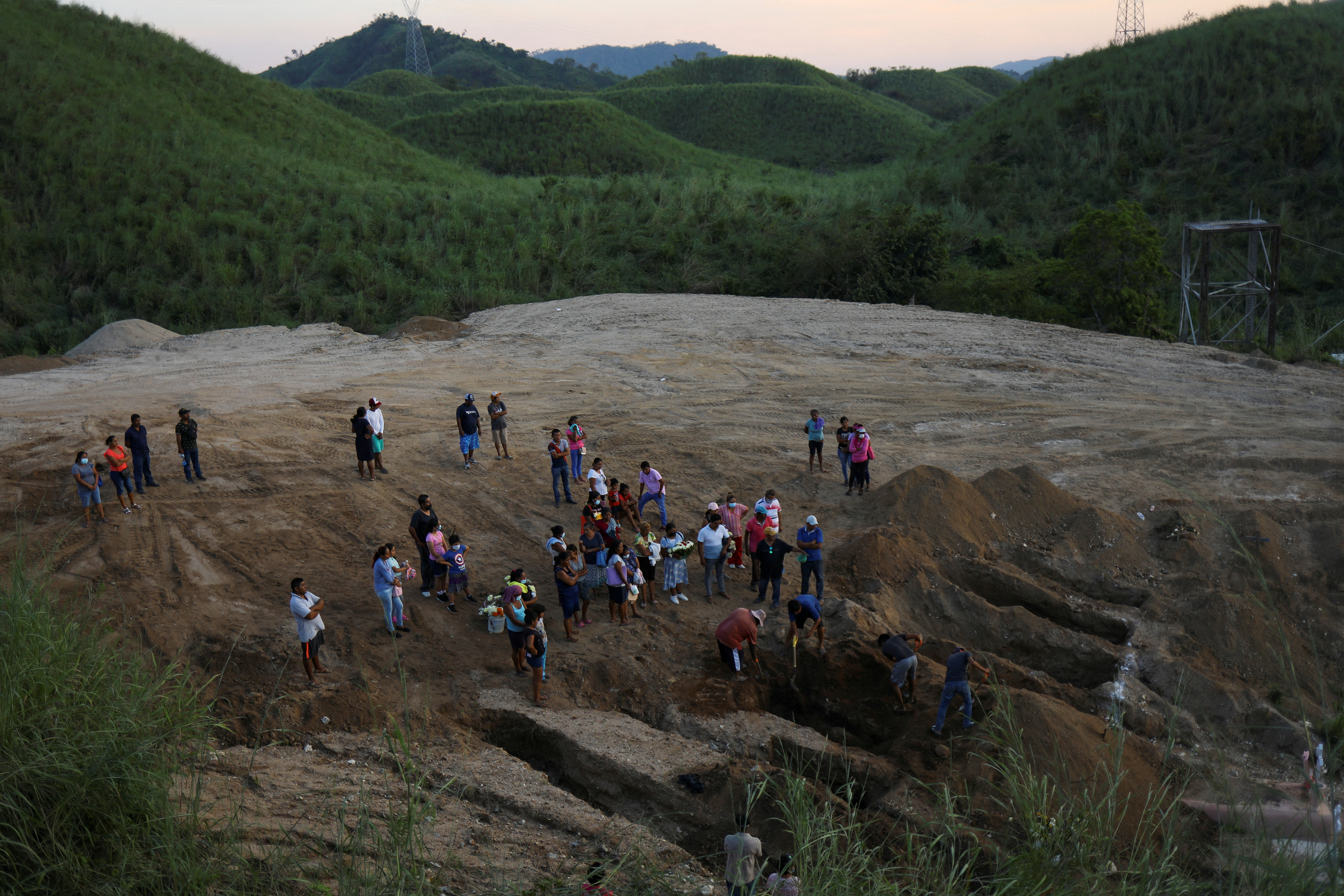 Relatives look on as the coffin of Jose Ramiro Castro Garcia, who died during Hurricane Otis while working aboard a ship, is buried at El Palmar cemetery in Acapulco, Mexico, November 3, 2023. 