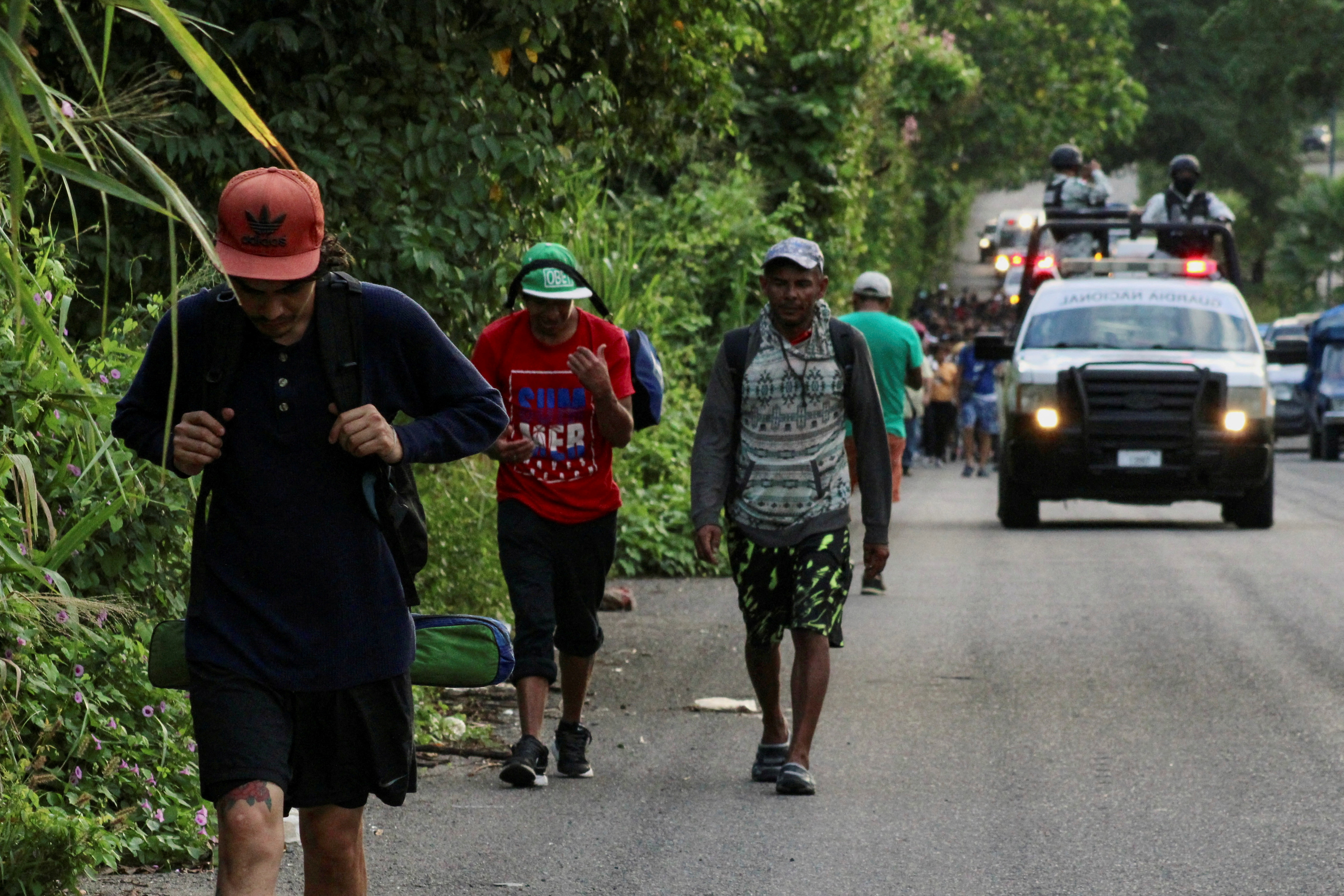 Migrants walk along the road in a caravan in an attempt to reach the U.S border, in Tapachula, Mexico November 5, 2023. 