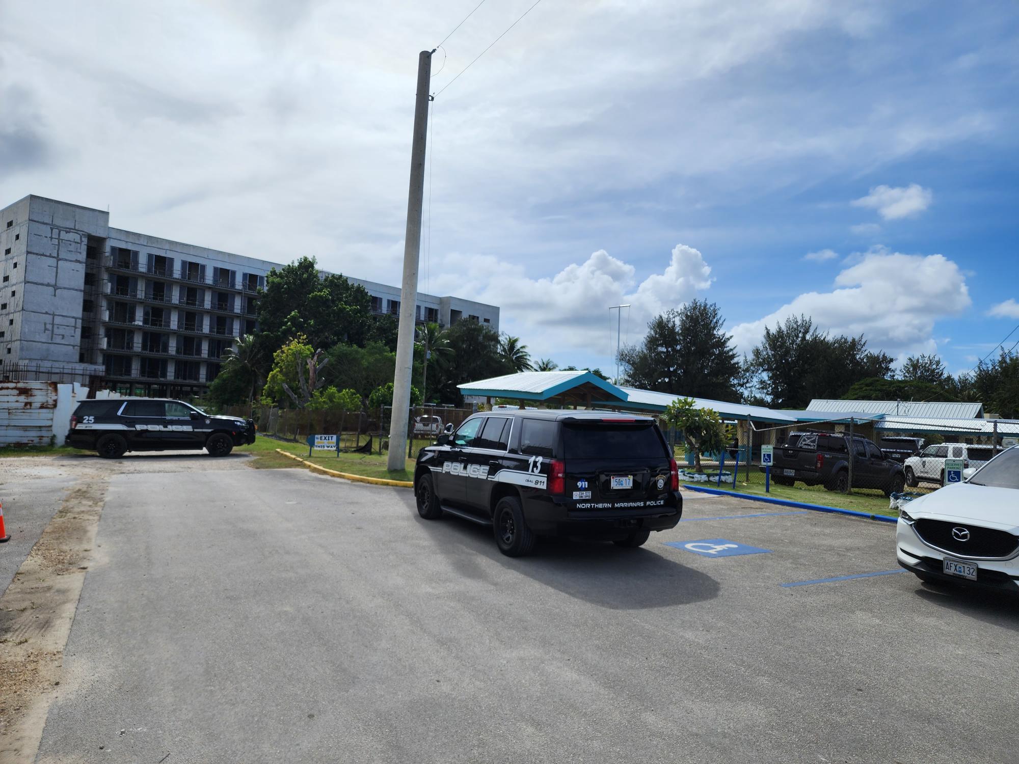 Police vehicles are seen at the entrances and exits of Francisco M. Sablan Middle School after a student threatened to blow up the campus on Thursday.