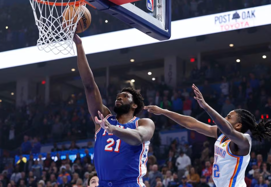 Philadelphia 76ers center Joel Embiid (21) shoots as Oklahoma City Thunder guard Cason Wallace (22) defends during the first quarter at Paycom Center in Oklahoma City, Oklahoma, Nov. 25, 2023.