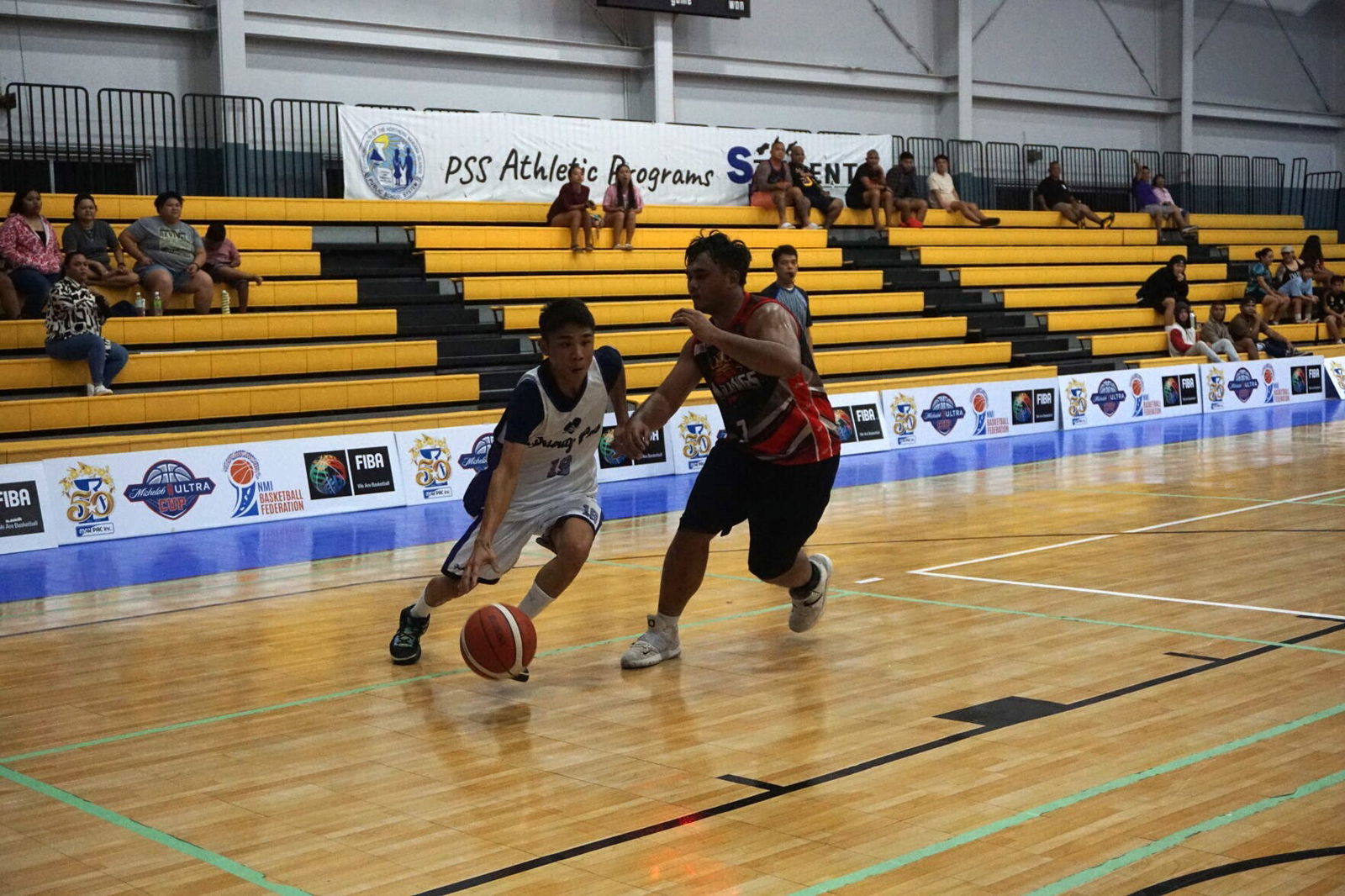 Priority Care's Justice Aldan attempts to drive past Marpac's Greg Sablan during a semifinal game of the 2023 R&J Wine and Liquor Inter-Government/Business League at the Ada gym on Thursday.