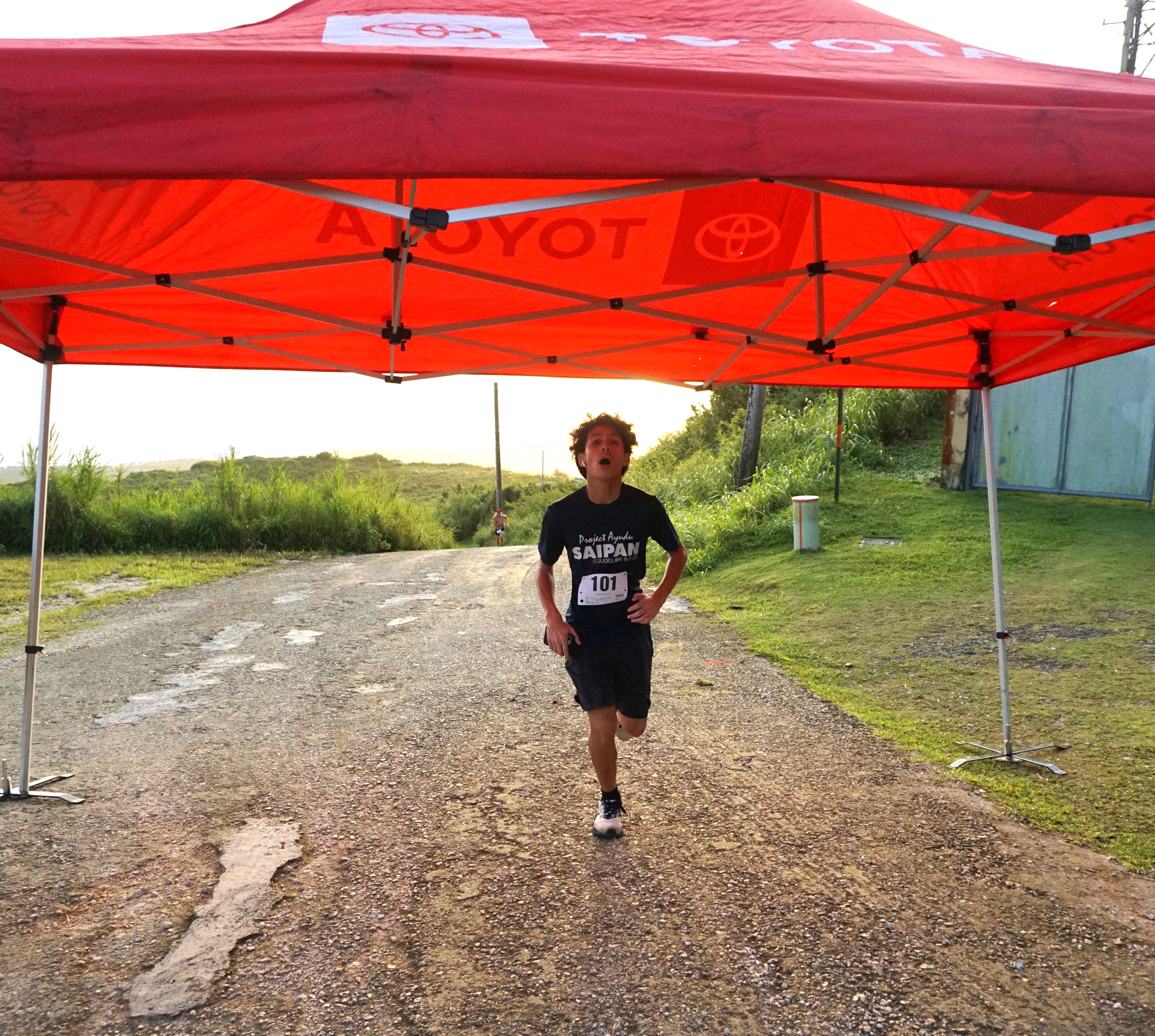 Victor Nash Santos pushes through the finish line of the 2023 NMA Mt. Tapochao Turkey Trot on Thursday.