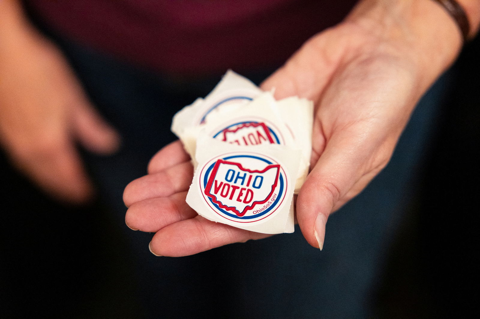 A poll worker holds stickers as voters in Ohio decide whether to enshrine abortion protections into the state constitution, in Columbus, Ohio, U.S. November 7, 2023. 