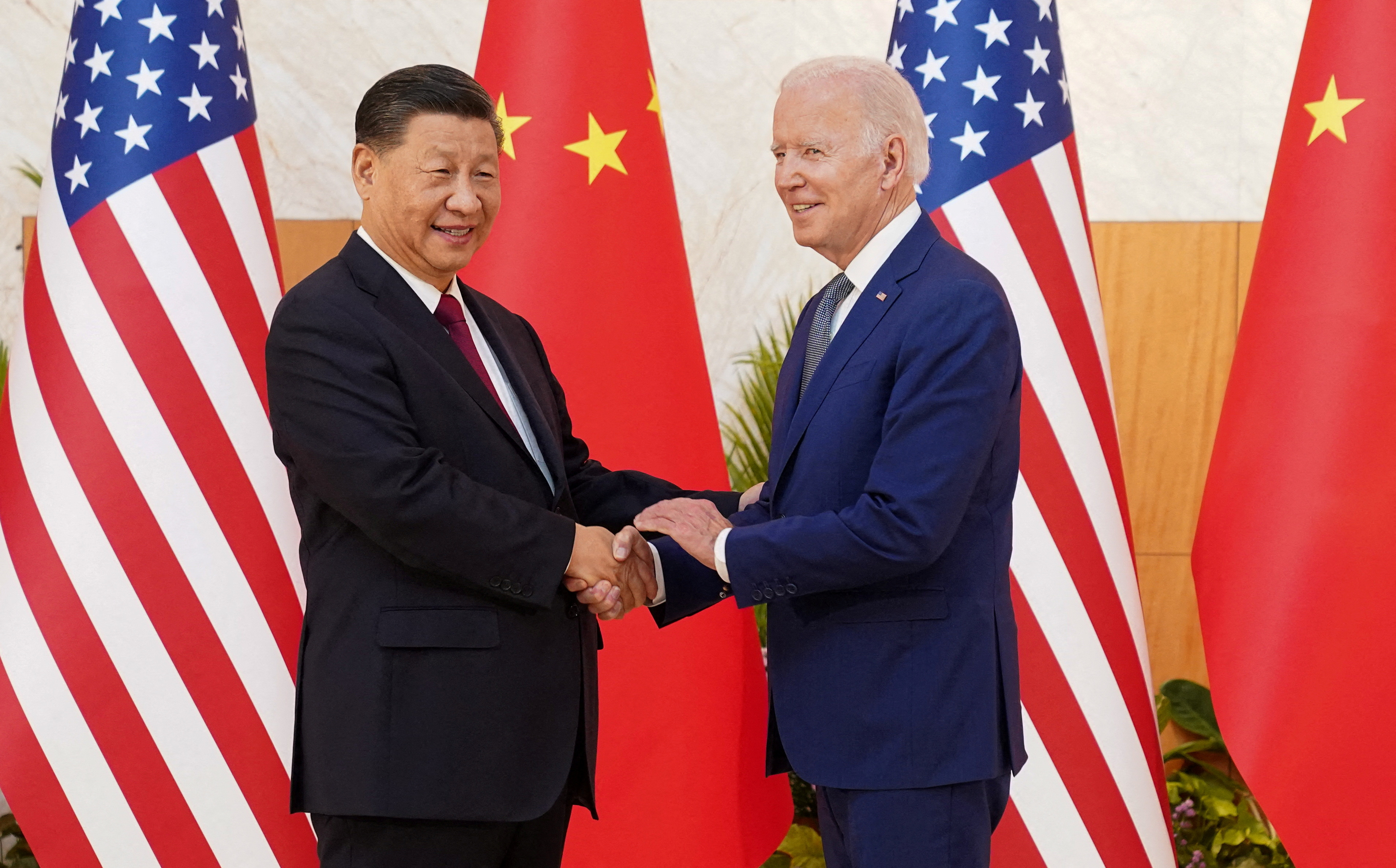 U.S. President Joe Biden shakes hands with Chinese President Xi Jinping as they meet on the sidelines of the G20 leaders' summit in Bali, Indonesia, November 14, 2022. 