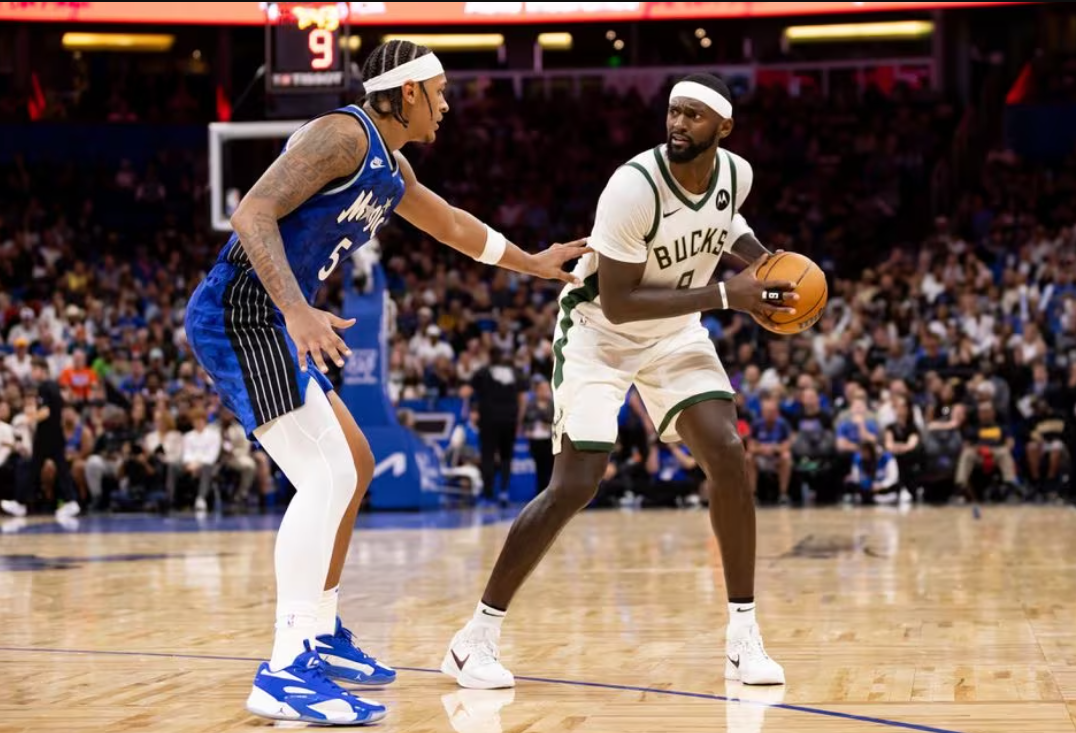 Orlando Magic forward Paolo Banchero (5) defends Milwaukee Bucks forward Bobby Portis (9) during the second half at Amway Center in Orlando, Florida, Nov. 11, 2023.