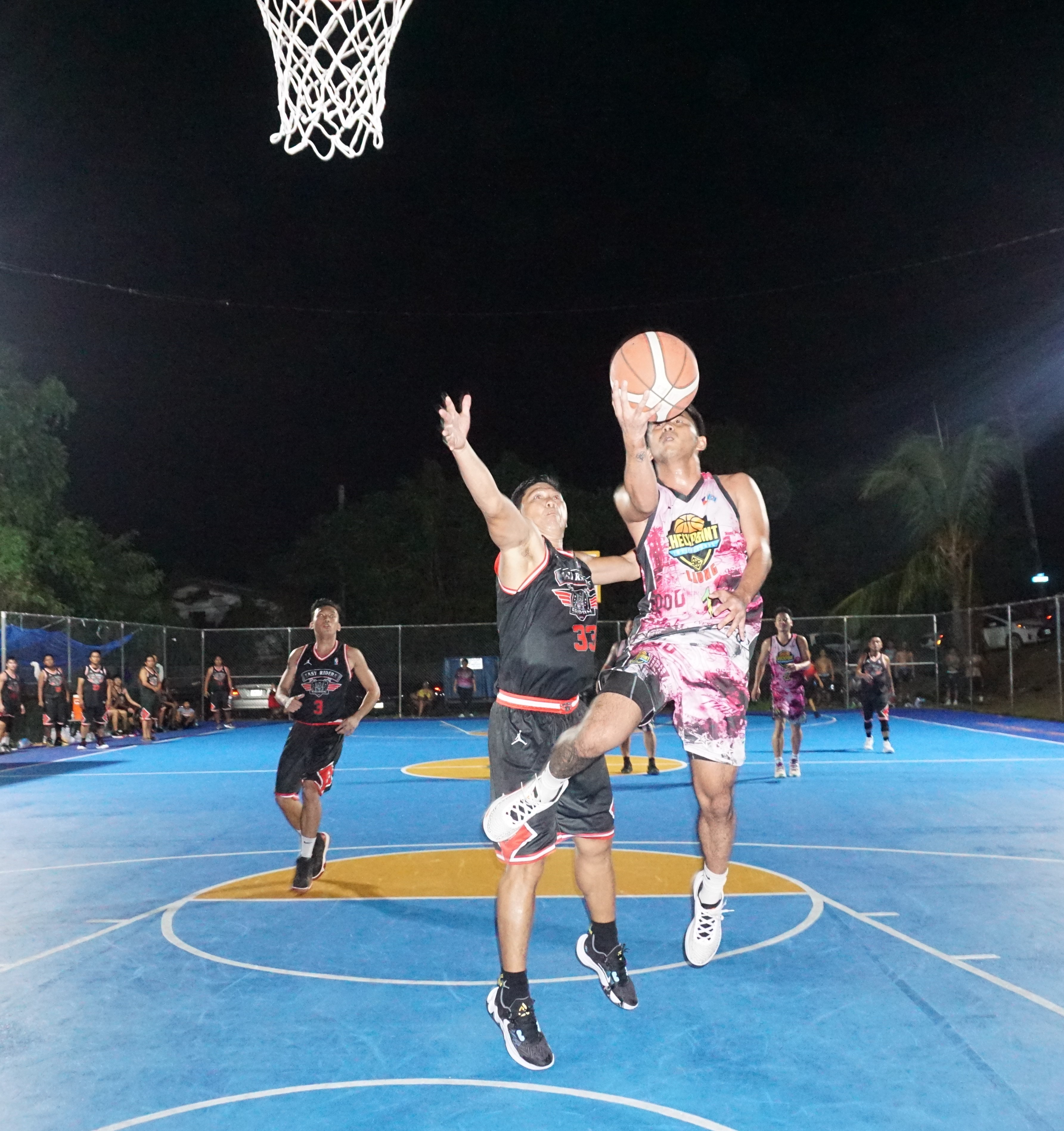 In this file photo, Checkpoint's Keith Santos extends for the finish against the Easy Riders during an open division game of the 2023 Saipan Magalahi Eagles Club Invitational Basketball League at the Gualo Rai basketball court. 