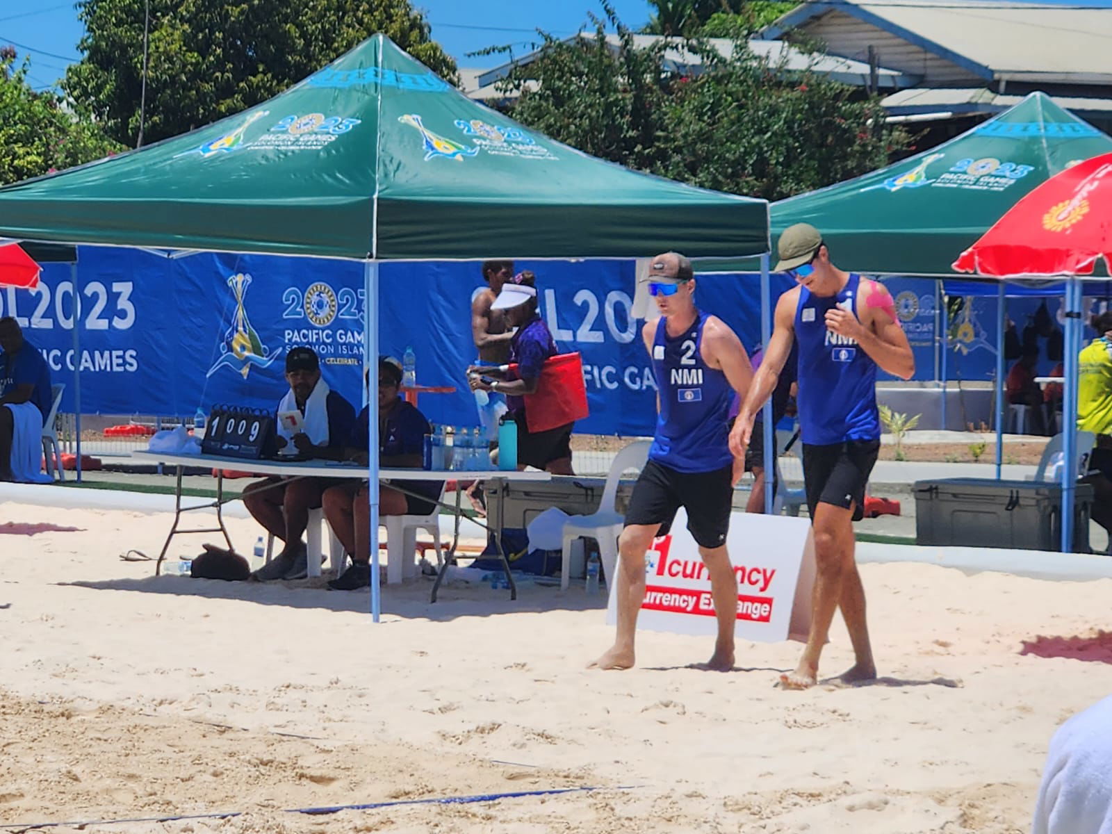 Logan Mister and Andrew Johnson walk back to the court for the second set of their game against Tonga.