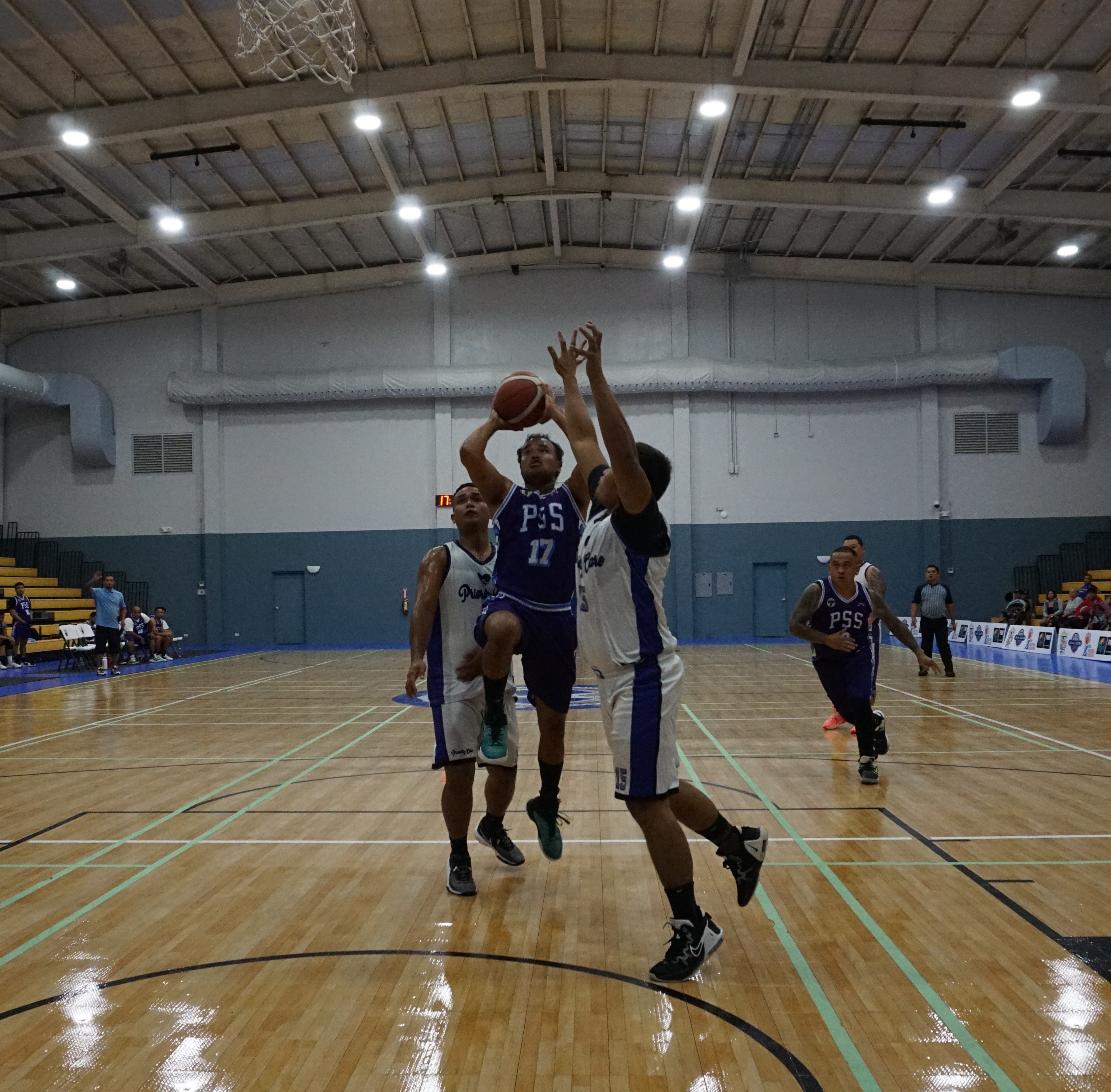 PSS's Jacoby Winkfield goes up for the shot in between two defenders during a playoff game of the 2023 R&J Wine and Liquor Inter-Government/Business League at the Ada gym on Tuesday.