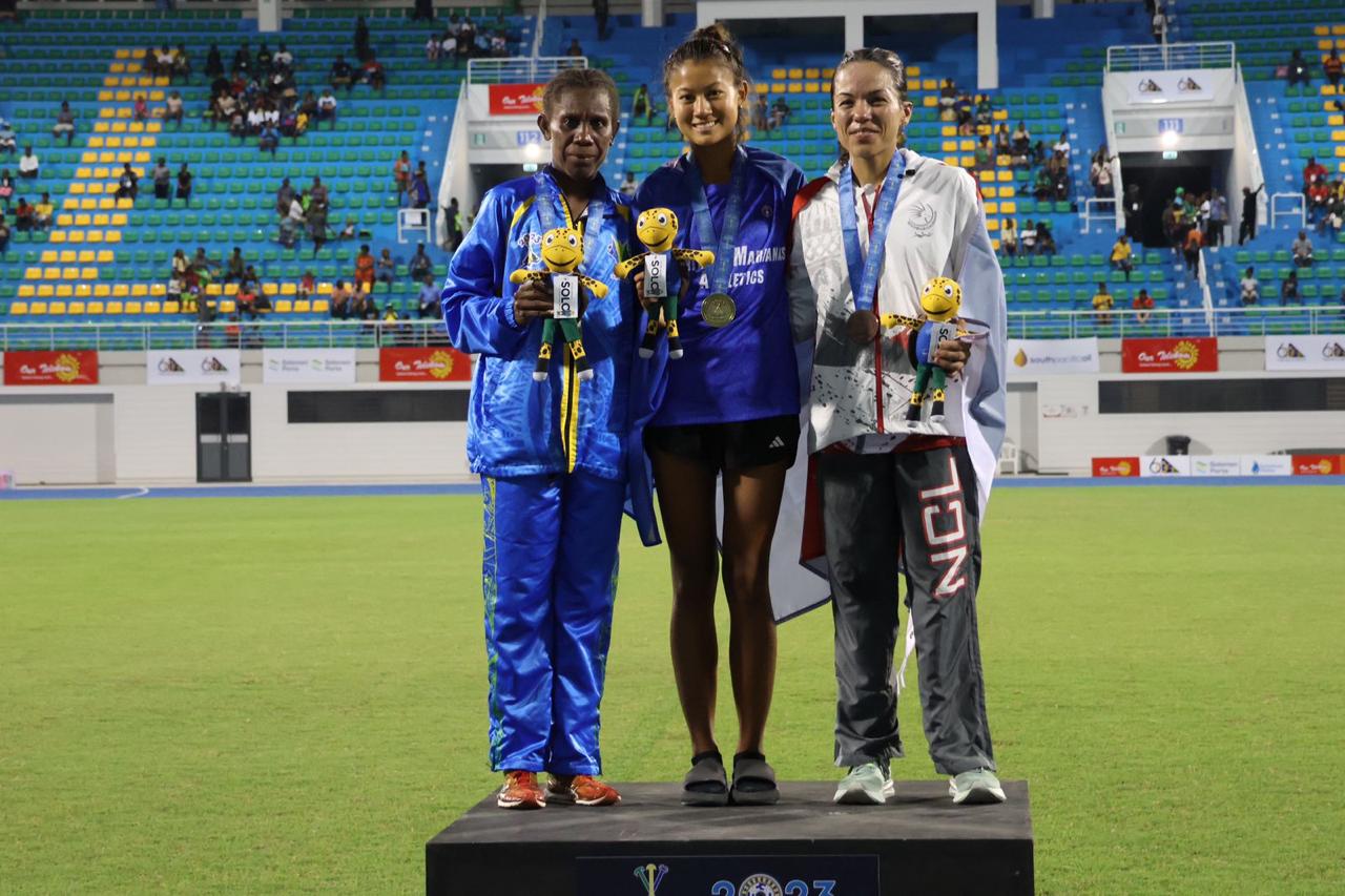 Tania Tan, center, at the medal podium again after winning the 10K race.