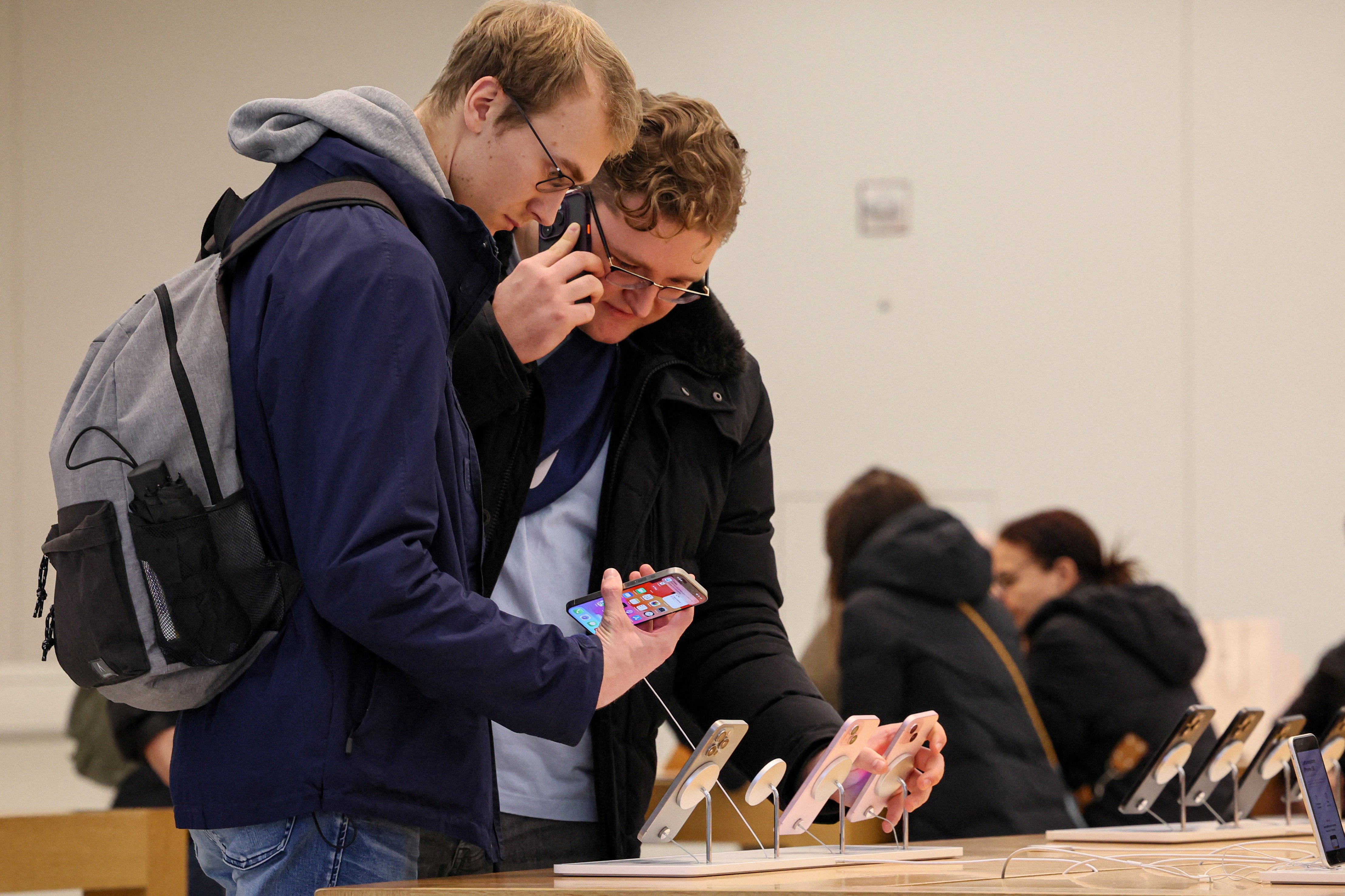 People shop at an Apple store during Black Friday shopping in New York City, U.S., November 24, 2023. 