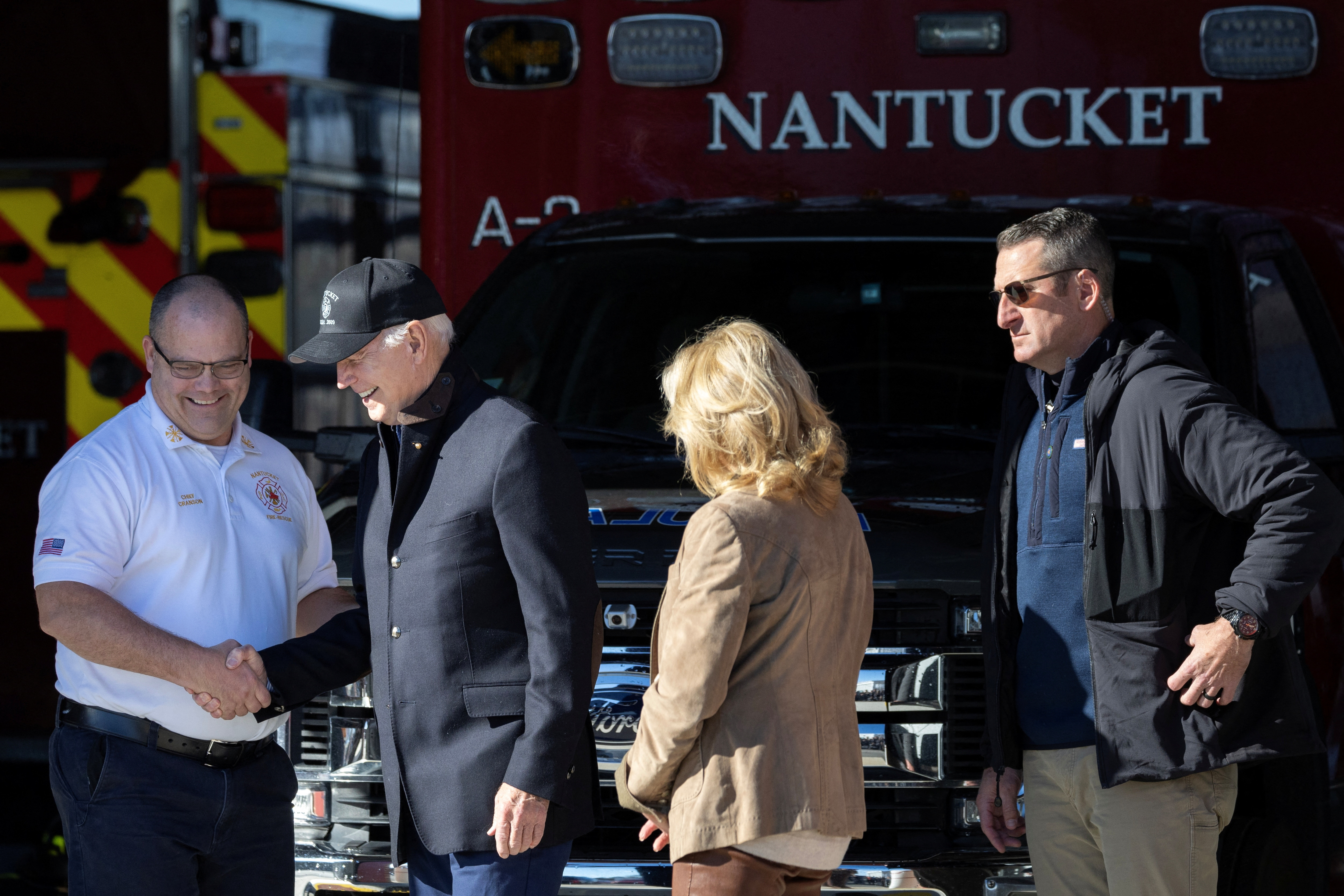 U.S. President Joe Biden greets Nantucket Fire Department Chief Cranson alongside First Lady Jill Biden, at the Nantucket Fire Department in Nantucket, Massachusetts, U.S, November 23, 2023. 