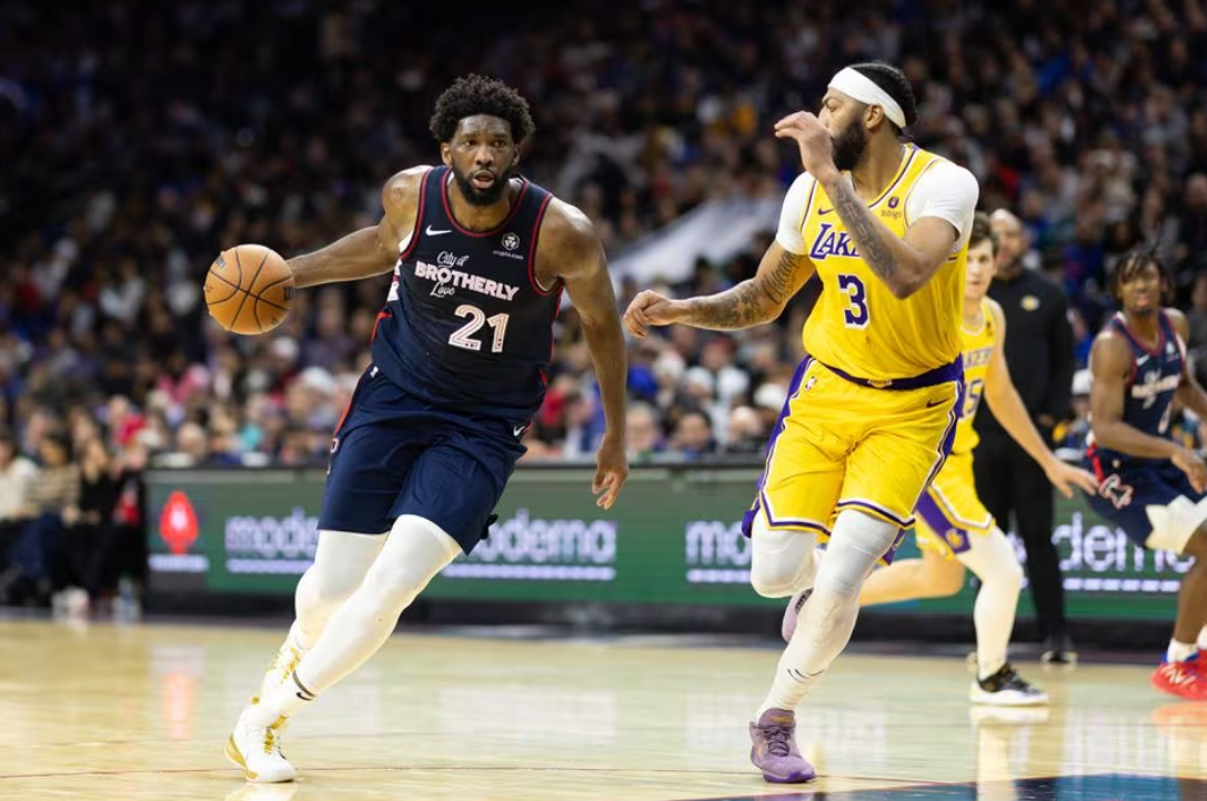 Philadelphia 76ers center Joel Embiid (21) dribbles the ball against Los Angeles Lakers forward Anthony Davis (3) during the third quarter at Wells Fargo Center in Philadelphia, Pennsylvania, Nov. 27, 2023.