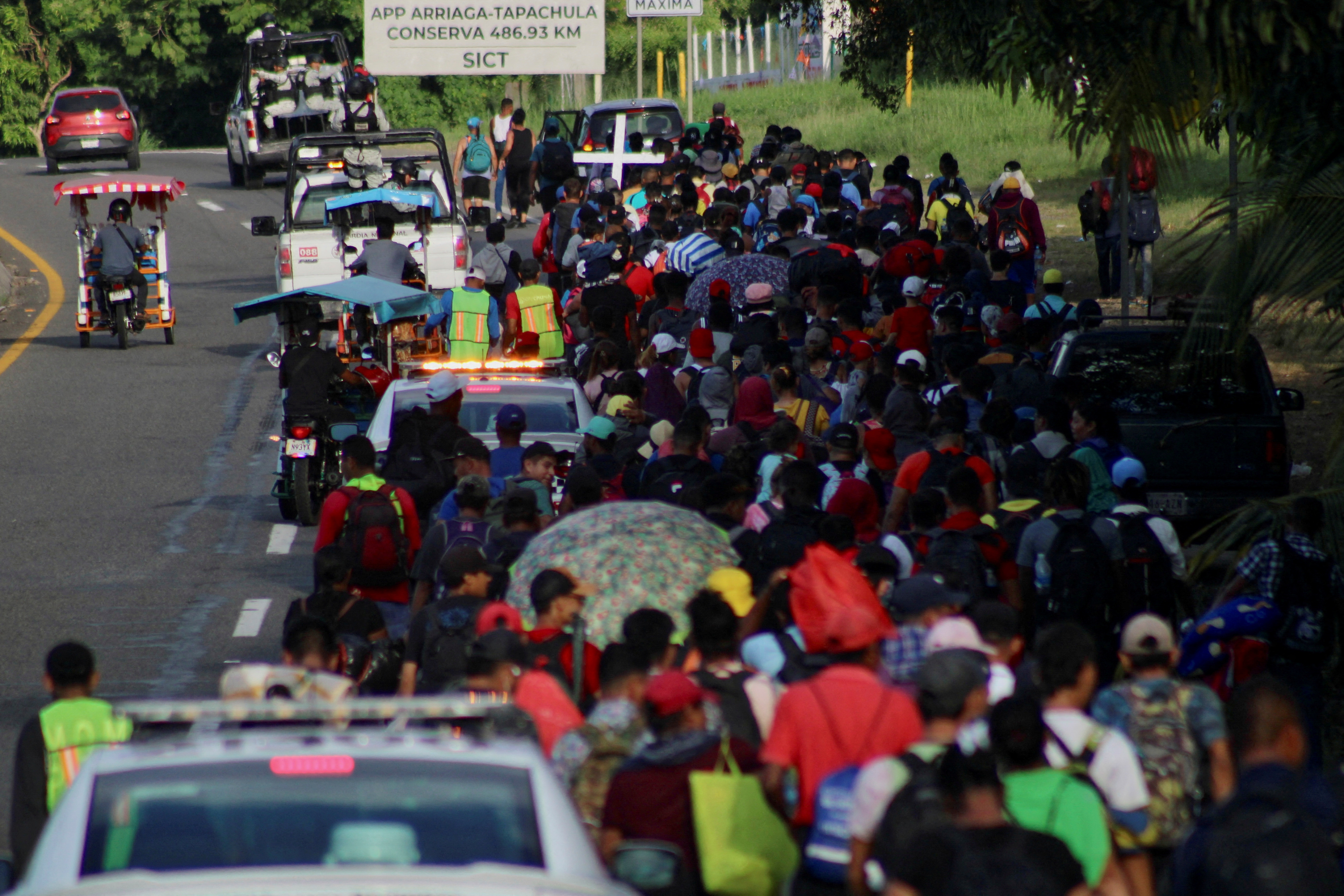 Migrants walk along the road in a caravan in an attempt to reach the U.S border, in Tapachula, Mexico November 5, 2023. 