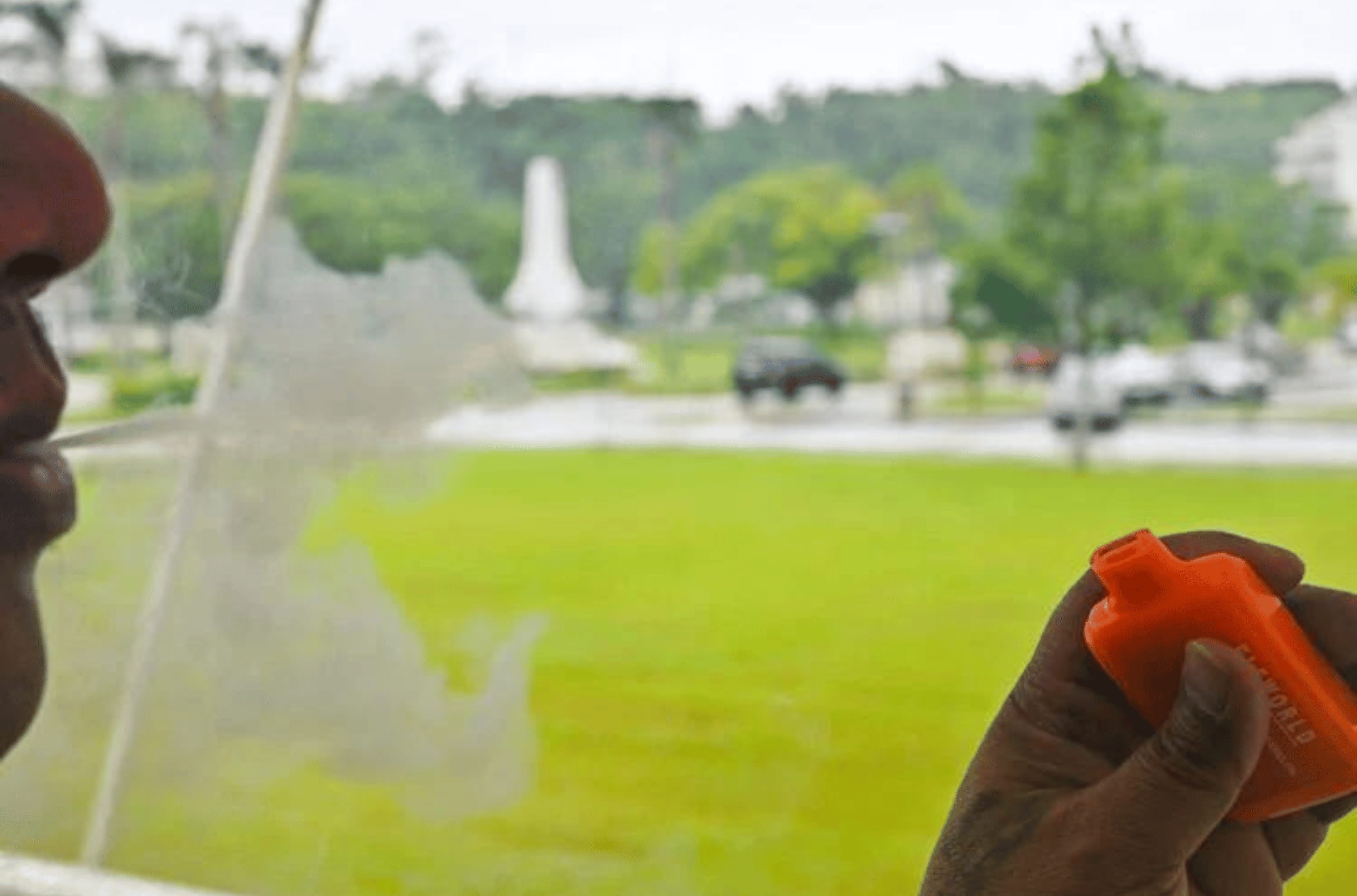 A person blows a cloud of smoke as he vapes Monday Aug. 14, 2023 in Hagåtña. 