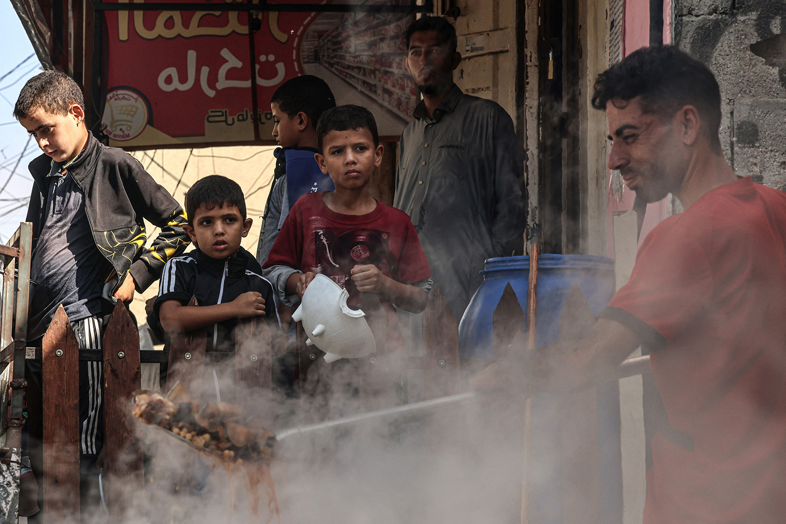 Palestinian children queue to receive a portion of food at a makeshift charity kitchen in Rafah in the southern Gaza Strip on Nov. 8, 2023. (Said Khatib/AFP via Getty Images/TNS)