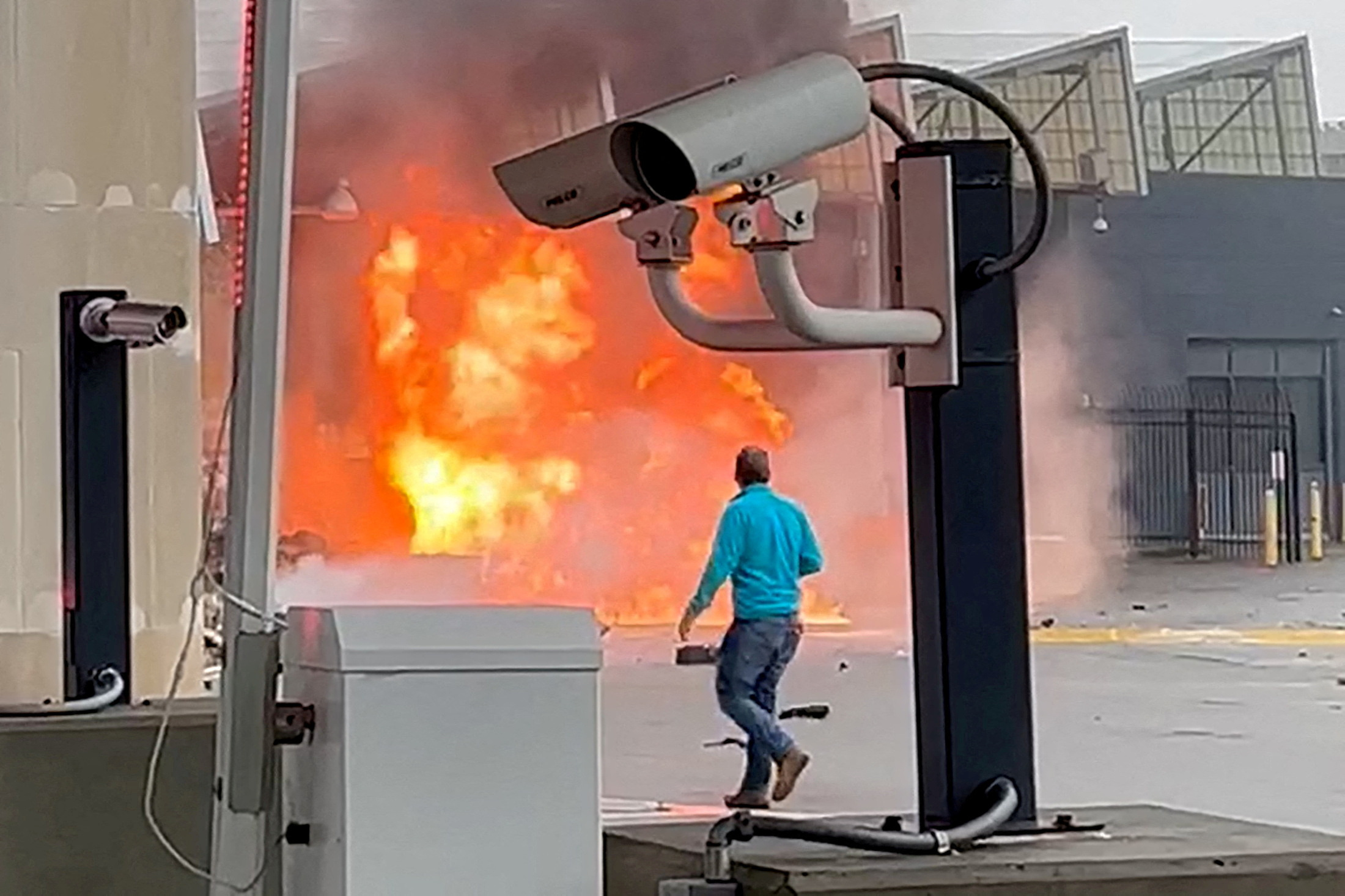 A vehicle burns at the Rainbow Bridge U.S. border crossing with Canada, in Niagara Falls, New York, U.S. November 22, 2023 in a still image from video. 