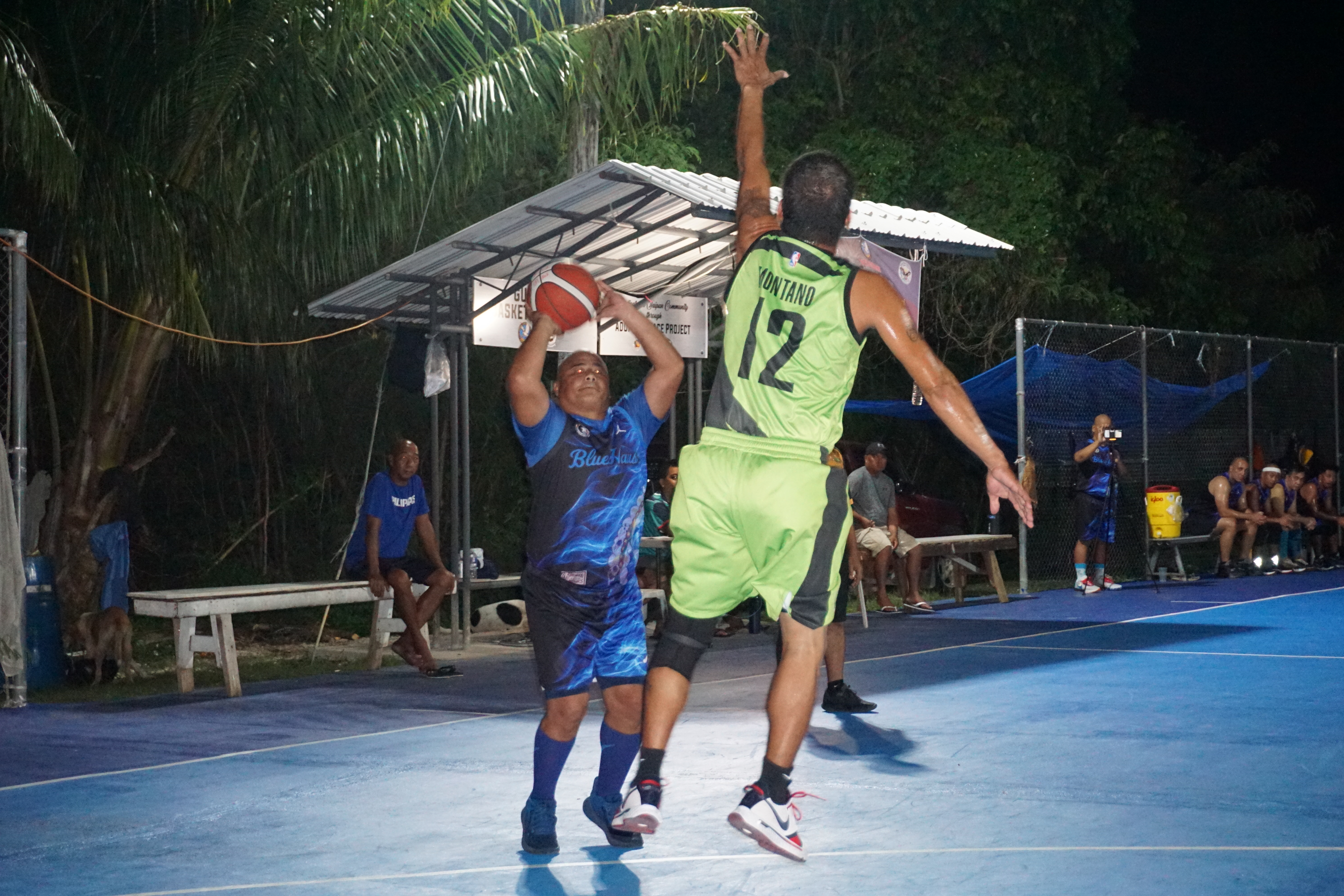 Blue Haus's Tony Diaz pulls up for the contested three-point shot against JSN during a masters division semifinal game of the 2023 Saipan Magalahi Eagles Club Invitational Basketball League at the Gualo Rai basketball court.