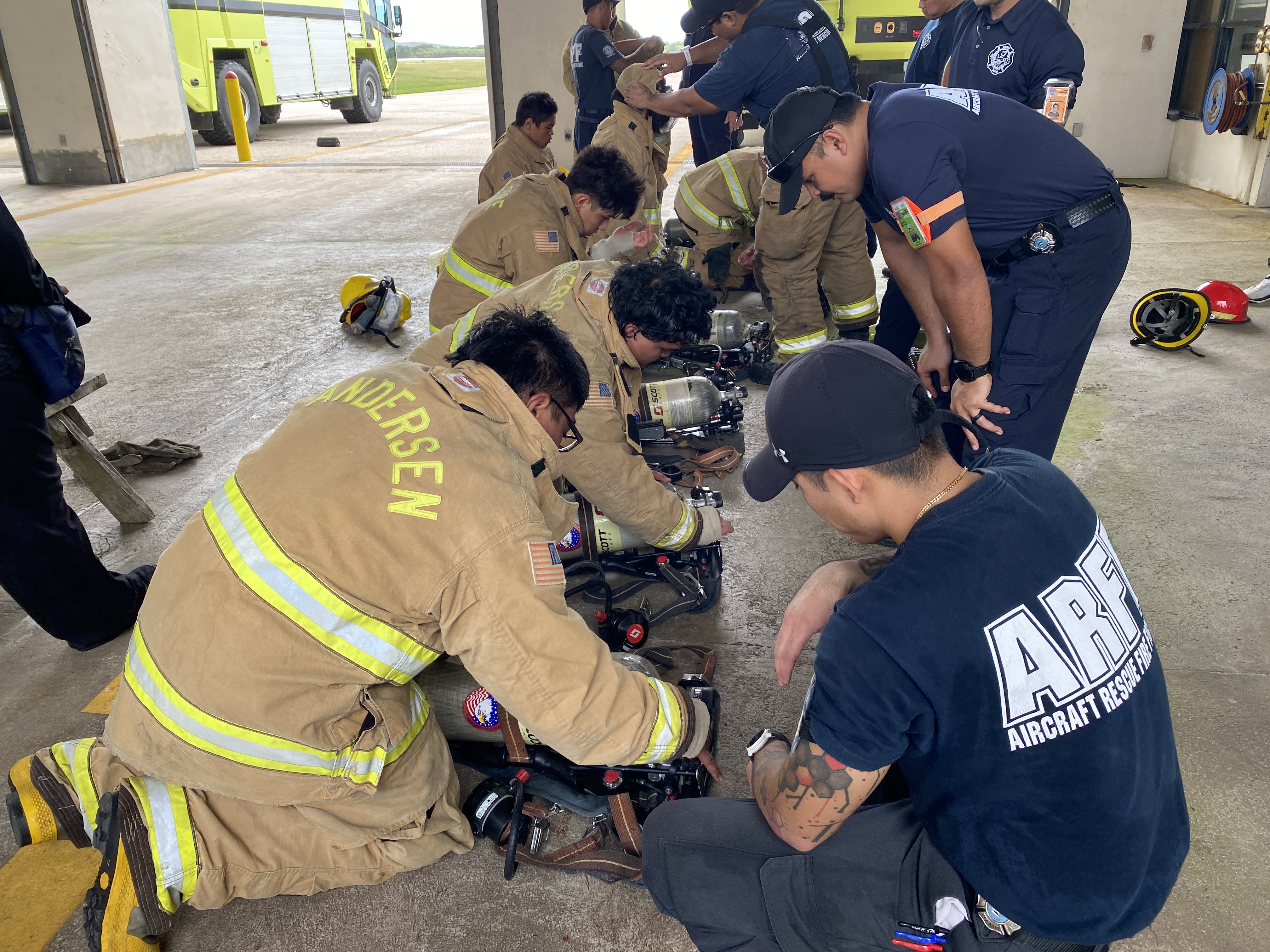 The trainees learn how to use a firefighting self-contained breathing apparatus.
