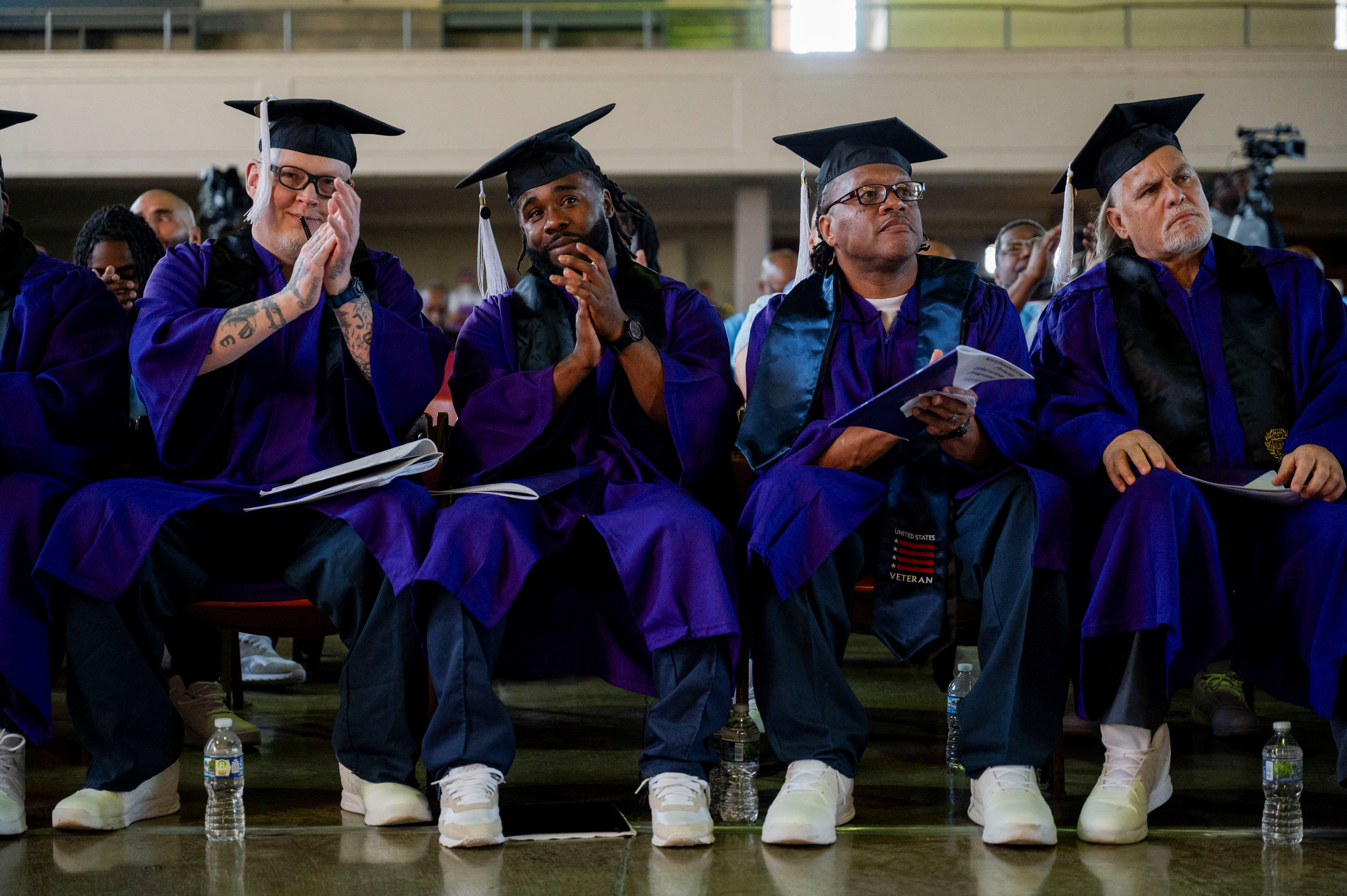 Members of the graduating class of the Northwestern Prison Education Program clap before receiving their bachelor's degrees from Northwestern University during a graduation ceremony for students who went through the inaugural class of the Northwestern Prison Education Program at Stateville Correctional Center in Crest Hill, Illinois, U.S., November 15, 2023. 