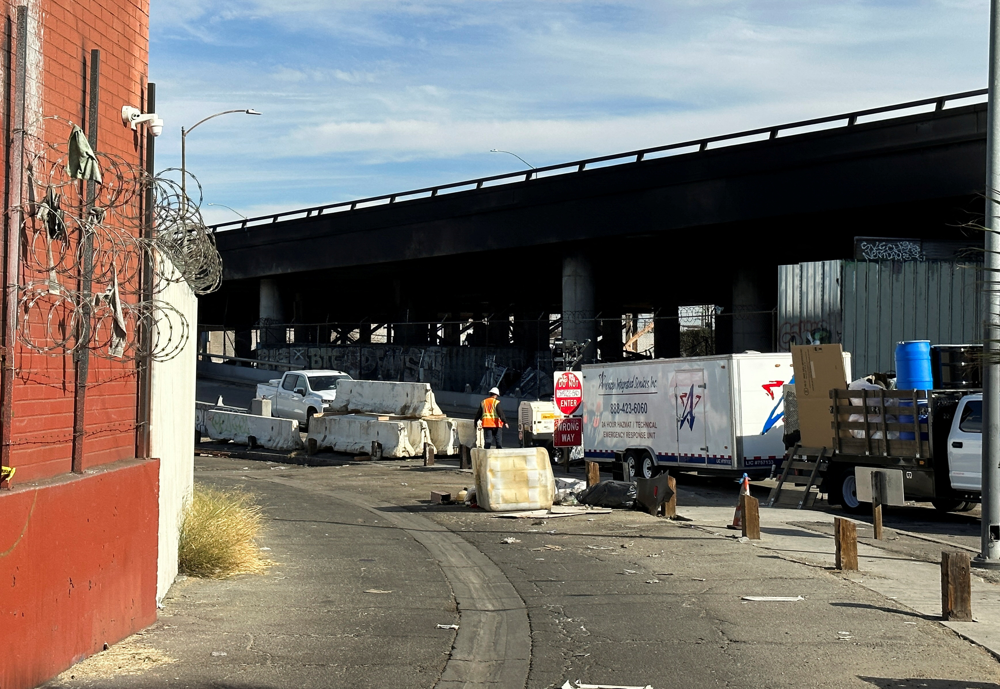 A crew member works in the area, where a fire erupted over the weekend, shutting down a heavily trafficked corridor in Los Angeles, California, U.S., November 13, 2023.