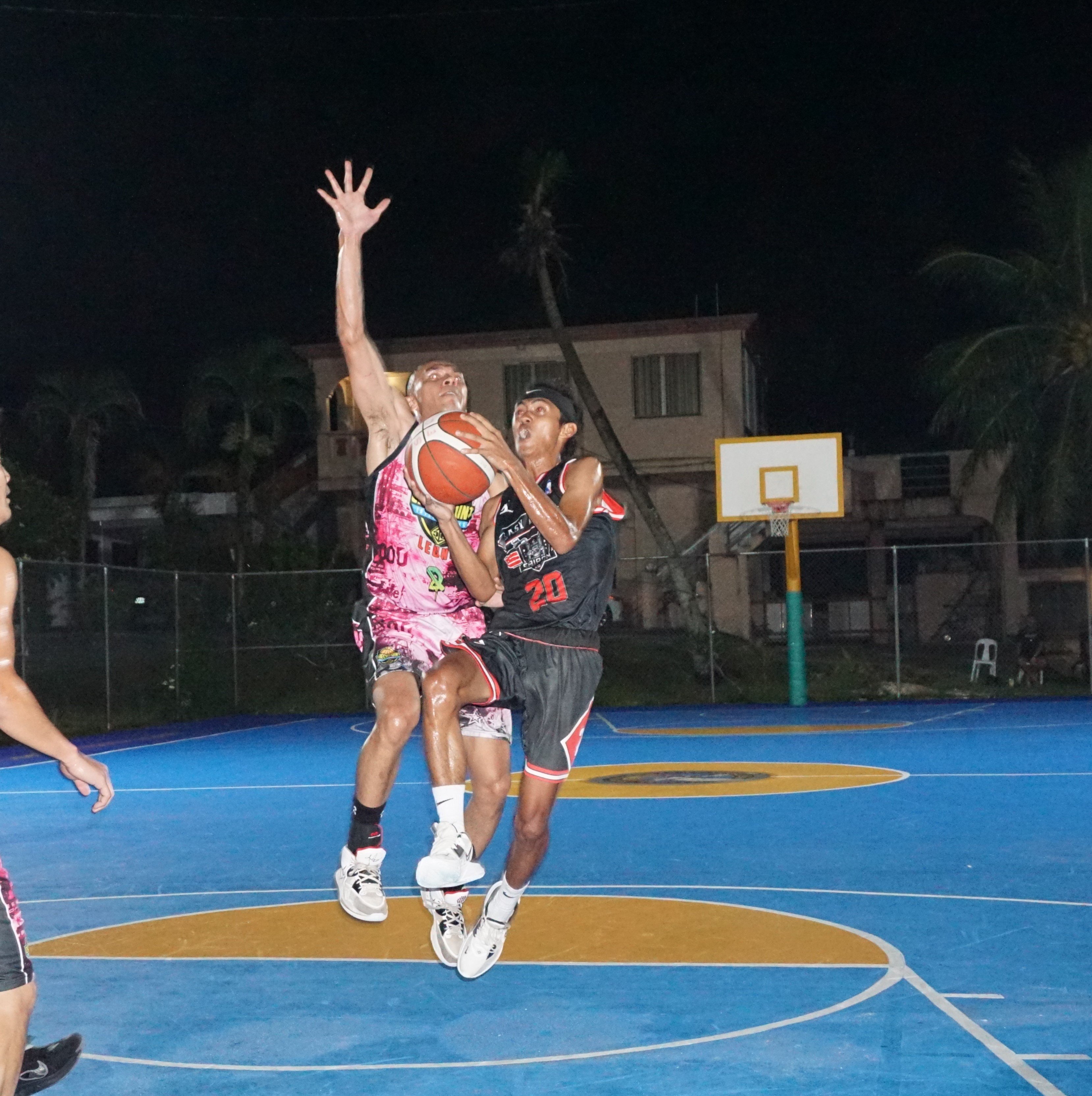 Easy Riders' Renren Gaviola goes up for the finish as Checkpoint's Sid Quan attempts the chasedown block during a playoff game of the 2023 Saipan Magalahi Eagles Club Invitational Basketball League at the Gualo Rai basketball court on Wednesday.