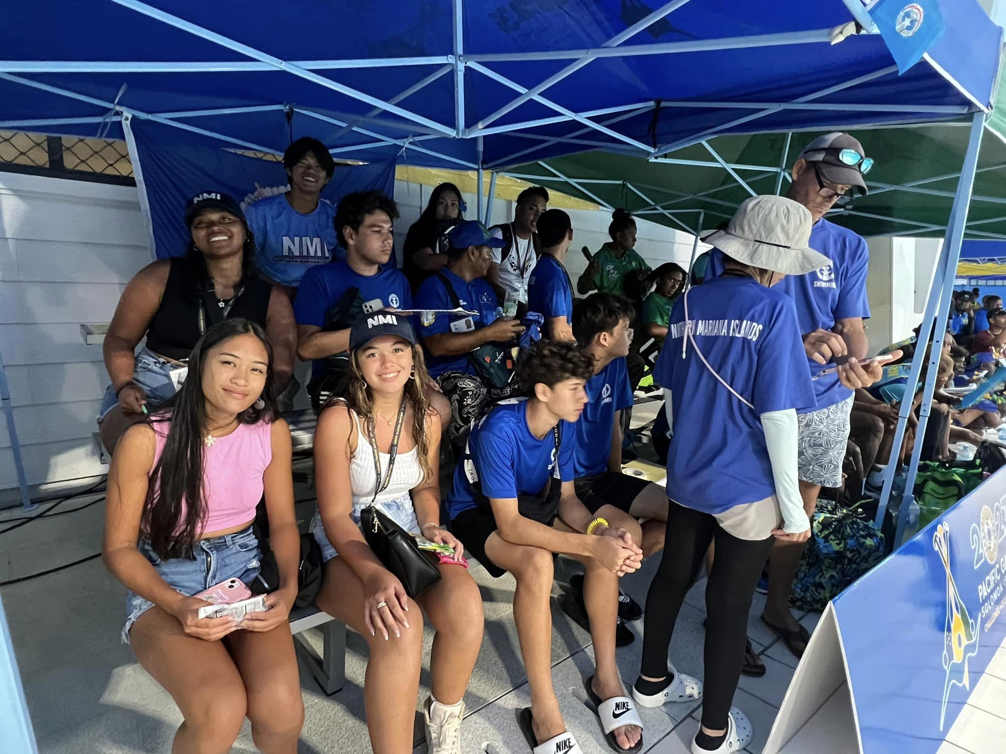 Team Marianas athletes and officials attend the opening day of the swimming competition to cheer on NMI swimmers.